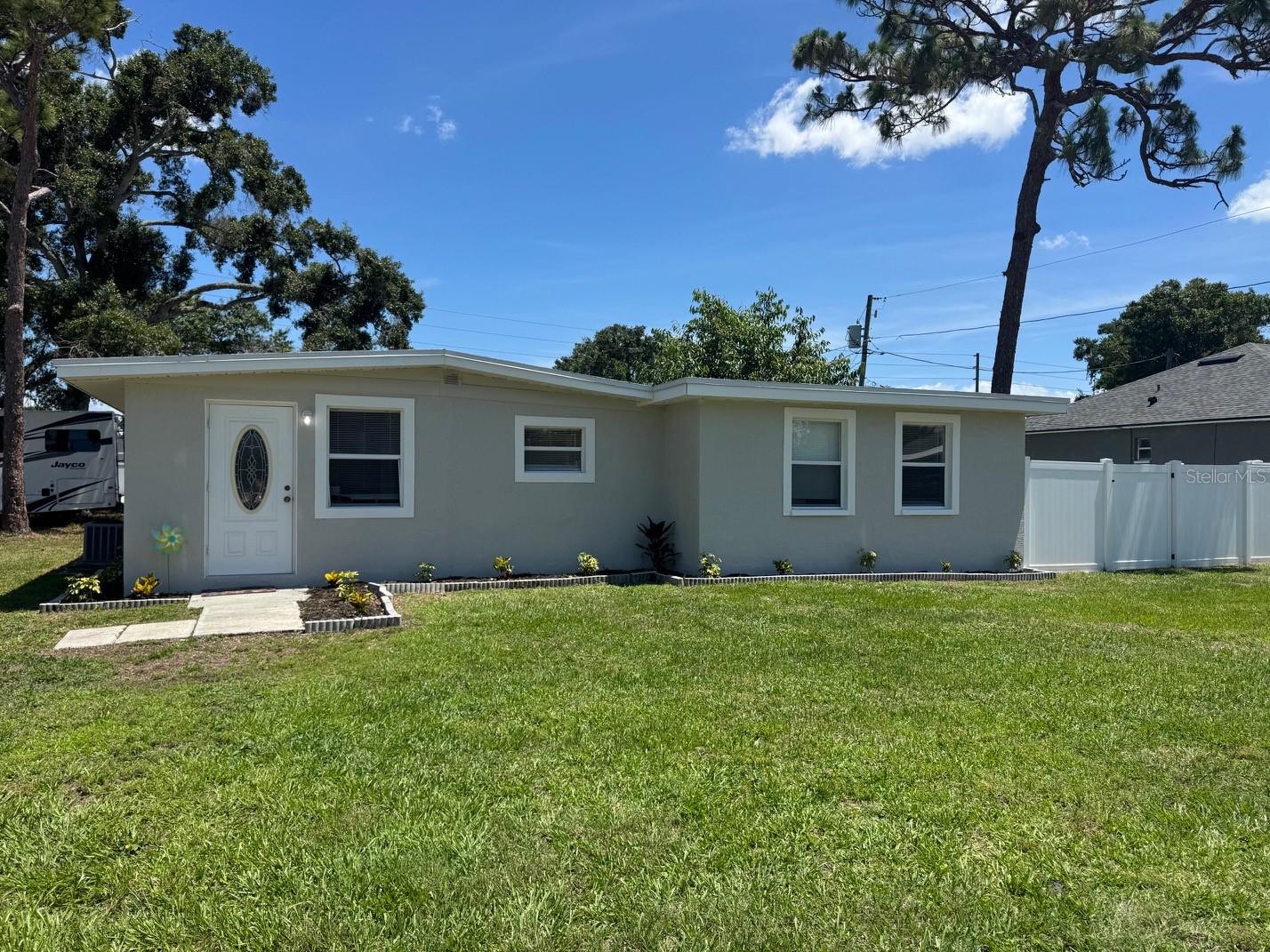 Welcome to this beautifully updated Corner Lot Home in NO Flood Zone in the heart of Pinellas Park on 60 x 110 Large lot offering modern upgrades, prime location, and access to some of the area’s best recreation and future development. Major improvements include a 2022 roof, newer windows, all newer doors, Newer tankless water heater, Newer HVAC system, and Newer stylish commercial-grade Vinyl plank flooring throughout, Painted inside and outside and Bath Tub and walls Refurbished. The exterior is fully fenced with a newer vinyl fence—perfect for privacy, pets, or entertaining.   Enjoy an unbeatable central location just 15 minutes to Downtown St. Petersburg and approximately 20 minutes to Tampa International Airport, making commuting, dining, and travel effortless.  Outdoor and recreation lovers will appreciate being near multiple parks and amenities, including the newly opened Sprowls Horizon Sports Park, a $26M state-of-the-art complex featuring turf baseball fields, multipurpose fields, batting cages, playgrounds, and even an outdoor hockey rink, designed to host tournaments and community events year-round . This major investment is helping transform the area into a regional sports destination and economic hub.  Additional nearby green spaces and recreation include local neighborhood parks, plus easy access to larger Pinellas County destinations like Lake Seminole Park, offering trails, boating, and wildlife viewing, and the award-winning beaches and waterfront parks throughout the county. Looking ahead, the area continues to grow with exciting redevelopment projects such as Davis Commons, a planned city-center gathering space featuring an amphitheater, splash pad, walking trails, and future mixed-use dining and retail—adding long-term value and vibrancy to the community . This home combines move-in-ready upgrades, strong location, and proximity to major recreational and redevelopment projects—making it an excellent opportunity for both homeowners and investors alike.