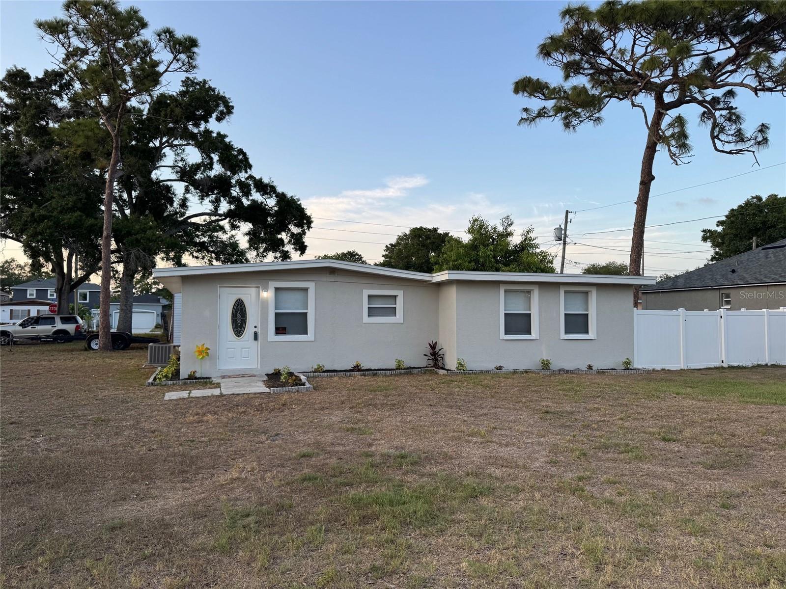 Welcome to this beautifully updated Corner Lot Home in NO Flood Zone in the heart of Pinellas Park on 60 x 110 Large lot offering modern upgrades, prime location, and access to some of the area’s best recreation and future development. Major improvements include a 2022 roof, newer windows, all newer doors, Newer tankless water heater, Newer HVAC system, and Newer stylish commercial-grade Vinyl plank flooring throughout, Painted inside and outside and Bath Tub and walls Refurbished. The exterior is fully fenced with a newer vinyl fence—perfect for privacy, pets, or entertaining.   Enjoy an unbeatable central location just 15 minutes to Downtown St. Petersburg and approximately 20 minutes to Tampa International Airport, making commuting, dining, and travel effortless.  Outdoor and recreation lovers will appreciate being near multiple parks and amenities, including the newly opened Sprowls Horizon Sports Park, a $26M state-of-the-art complex featuring turf baseball fields, multipurpose fields, batting cages, playgrounds, and even an outdoor hockey rink, designed to host tournaments and community events year-round . This major investment is helping transform the area into a regional sports destination and economic hub.  Additional nearby green spaces and recreation include local neighborhood parks, plus easy access to larger Pinellas County destinations like Lake Seminole Park, offering trails, boating, and wildlife viewing, and the award-winning beaches and waterfront parks throughout the county. Looking ahead, the area continues to grow with exciting redevelopment projects such as Davis Commons, a planned city-center gathering space featuring an amphitheater, splash pad, walking trails, and future mixed-use dining and retail—adding long-term value and vibrancy to the community . This home combines move-in-ready upgrades, strong location, and proximity to major recreational and redevelopment projects—making it an excellent opportunity for both homeowners and investors alike.