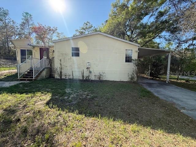 Situated on a spacious corner lot just shy of half an acre, this 4 bedroom, 2 bath mobile home offers plenty of room to spread out and enjoy the outdoors. The property features a covered carport for convenient parking and an enclosed porch, perfect for relaxing, entertaining, or creating additional living space to suit your needs. Inside, the home offers a functional layout with four bedrooms, a great room, dining area, and open kitchen - providing flexibility for a variety of living arrangements. The generous lot size allows for outdoor activities, gardening, or future enhancements, while the corner lot location offers added privacy and accessibility. Conveniently located in Dade City, this property is less than 1 mile to local shopping, dining, and major roadways (including I-75) while still offering a more relaxed, spacious setting. A great opportunity to make this property your own and take advantage of the space and potential it has to offer. Call today before it's too late!