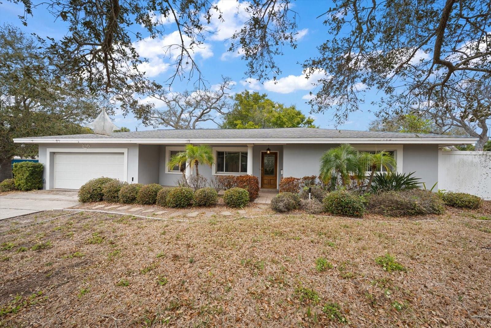 Situated on a generous corner lot in the highly sought-after Town of Belleair, this 3BR/2BA home offers charm, space, and incredible potential in one of Pinellas County’s most desirable communities. A welcoming front porch sets the tone, inviting you to slow down and enjoy peaceful mornings or relaxing evenings. Inside, crown molding adds a touch of character, while the light-filled family room creates a warm and comfortable gathering space for everyday living and entertaining. The kitchen features crisp white cabinetry, granite countertops, and a convenient breakfast bar for casual meals or morning coffee. A large laundry room, ideally located near the kitchen and garage, adds practicality and extra storage. The primary suite includes an ensuite bath with a tub/shower combination, while the additional bedrooms are spacious and share a hall bath. Step outside to the screened patio—an ideal retreat for enjoying Florida’s beautiful weather year-round. With its prime location close to shopping, local restaurants, golf courses, and the area’s famous sparkling beaches, this is a wonderful opportunity to make your home in the coveted Town of Belleair.