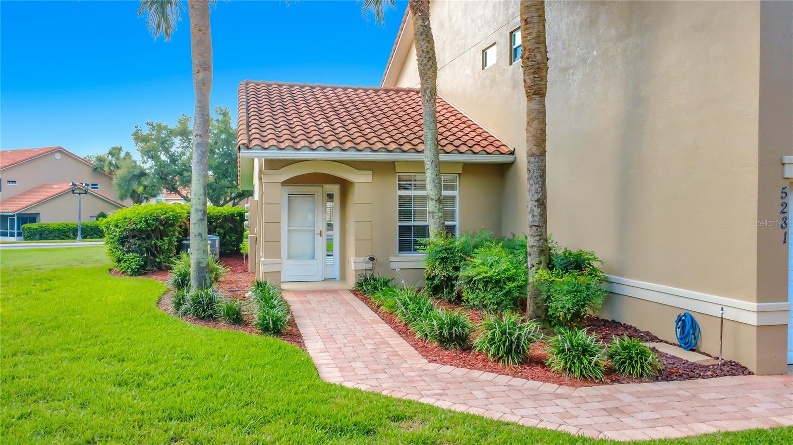 Welcome to Lakeside Landings, a gated, pet-friendly, all-ages community conveniently located just minutes from The Villages! This spacious ground-floor, end-unit condo offers 1,281 square feet of living space, a private entrance, paver driveway, and attached one-car garage with newly finished flooring for a clean, polished appearance.

Inside, you’ll find an open floor plan with cathedral ceilings, luxury vinyl plank flooring, granite countertops, beautiful cabinetry, and stainless-steel kitchen appliances approximately two years old. The washer and dryer are included and conveniently located inside the laundry closet. A newer water heater provides additional peace of mind.

The primary suite features a large walk-in closet and private bathroom with dual sinks, granite countertops, and a step-in shower. The spacious guest bedroom can comfortably accommodate a queen bed or two twin beds and offers generous closet space.

Relax on the large screened back porch overlooking a peaceful grassy area. Roll-down privacy screens provide additional shade and seclusion, making this the perfect place to enjoy your morning coffee or unwind in the evening.

Lakeside Landings offers an impressive selection of amenities, including a resort-style swimming pool with waterfalls, a second pool and spa, clubhouse, fitness center, ballroom, meeting and card rooms, billiards, library, pickleball, tennis, basketball, community activities, monthly events, and a dock on beautiful Lake Miona. Shopping, dining, medical facilities, and nightly entertainment at Lake Sumter Landing are only minutes away. Perfect as a primary residence or Florida getaway!