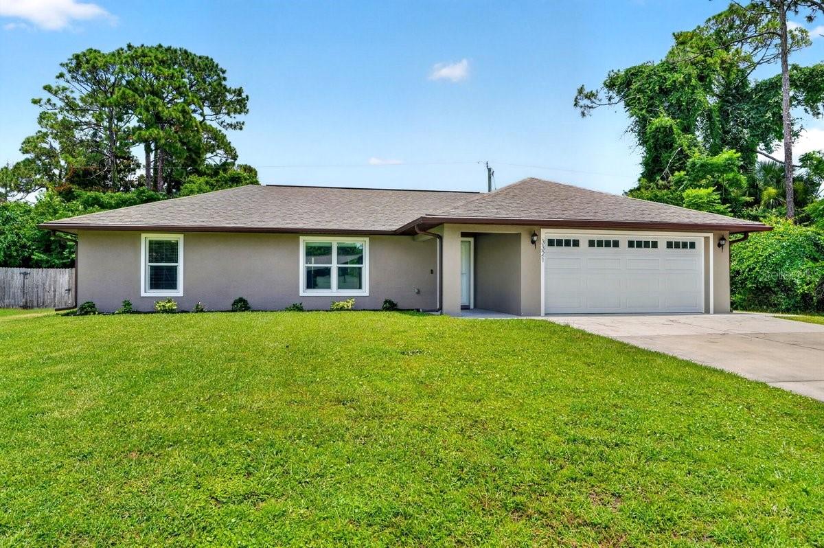 Welcome to this beautifully maintained 3-bedroom, 2-bath residence with an oversized 2-car garage in the heart of Edgewater. Built in 2021 and occupied only seasonally, this all-block construction home shows like new with minimal wear on the HVAC system, water heater, appliances, and finishes. Situated on a large elevated homesite in highly desirable Flood Zone X, where flood insurance is typically not required, the home also features hurricane impact windows and doors for added peace of mind and potential insurance savings. Inside, you'll find a light-filled open floor plan with vaulted ceilings, abundant windows, recessed lighting, stunning wood laminate flooring throughout, and a popular split-bedroom layout that offers privacy and functionality. The beautifully appointed kitchen showcases white soft-close cabinetry, quartz countertops, a spacious center island, and stainless steel Frigidaire appliances, while both bathrooms continue the upscale finishes with matching quartz surfaces and quality cabinetry. Window treatments are already in place, making this truly move-in ready. Step outside to the open rear patio, an ideal space for grilling, entertaining, or easily converting into a future screened porch. Offered fully FURNISHED turnkey, this home presents an exceptional opportunity for first-time homebuyers, investors, seasonal residents, or those looking to downsize without sacrificing quality. Conveniently located near top-rated schools, parks, boat ramps, shopping, dining, and entertainment, and just 15 minutes from the beach, this is one of the best values available in today's market. ALL INFORMATION IS ASSUMED ACCURATE BUT NOT GUARANTEED. ALL MEASUREMENTS ARE ESTIMATED. BUYERS AND THEIR AGENTS TO VERIFY ALL INFORMATION DEEMED IMPORTANT TO THEM.