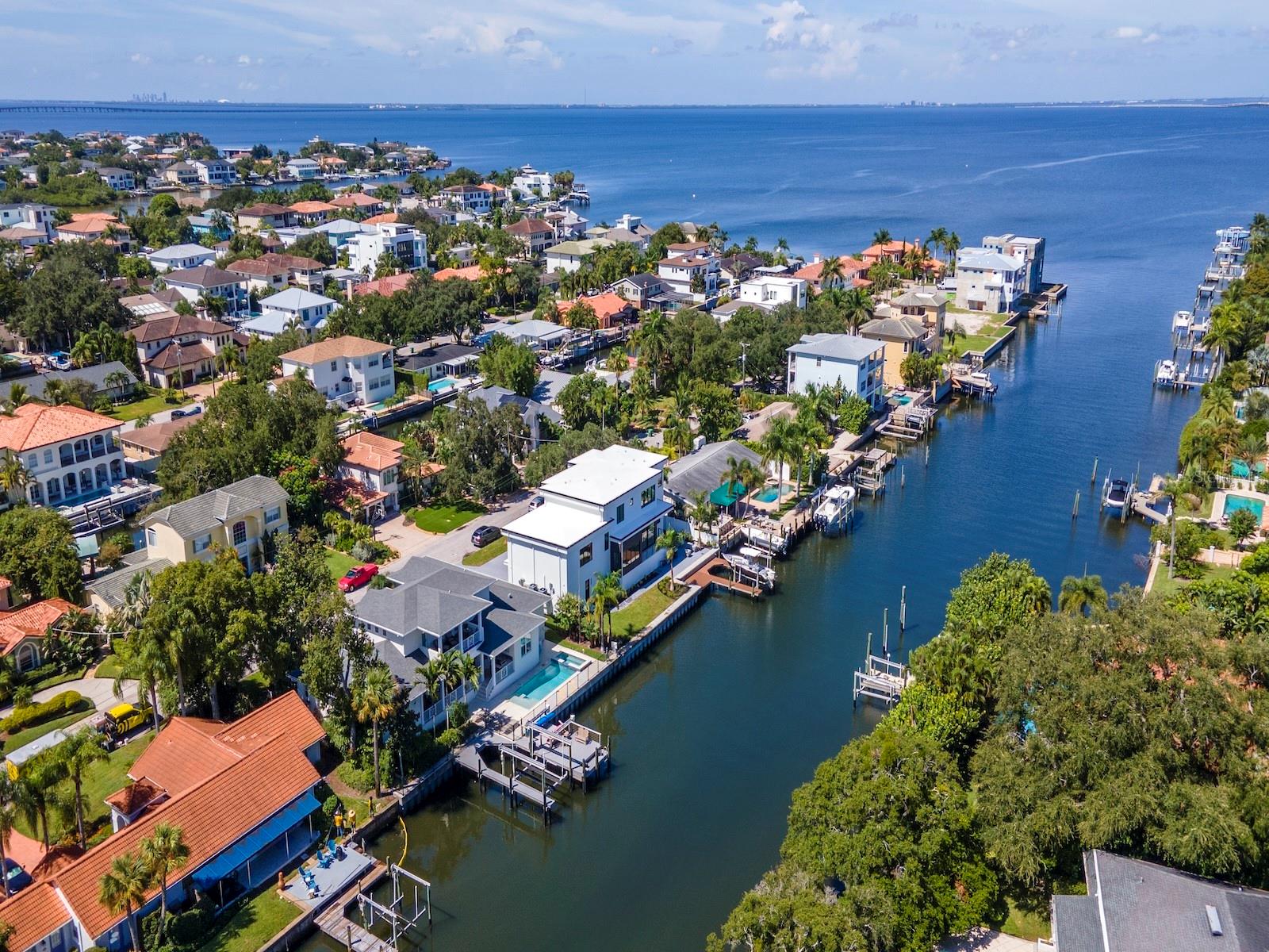**Unaffected By Both Hurricanes** This Immaculate Water Front Custom home is on a wide canal, with all the accessories a home of this caliber demands. The open floor plan makes entertaining or family gatherings a breeze. The gourmet eat in kitchen has water front dining, as well as casual seating at the island. Shaker solid wood cabinetry is complimented by among other things, a gas cook top, double wall ovens, ice maker, and a walk in panty. The covered lanai and full outdoor kitchen can be accessed from the kitchen or living areas. Adjacent to the kitchen is a mud room with office, and a separate laundry room. The main dining room, with coffered ceiling, has an attached climate controlled 300 bottle plus wine room. The First Floor primary suite is its own oasis, with views of the water from the seating area. There are 2 walk-in closets, each with built-ins. The bath has totally independent vanity areas, soaking tub and spa shower. The first floor also has an additional full bath and a one of a kind powder room. Three bedrooms can be found on the second floor. Two of them share a jack and jill bath with double sinks, while the third is en-suite. An oversized Sunset Balcony with 180 degree views finishes off the second level. Just a few steps away from the first floor lanai area is the pool, spa and sun deck terrace. Beyond that is the dual dock area. A 7,000 pound lift controls the paddle board, kayak, jet ski, swim out system, while the main dock 20,000 pound boat lift is a Captain's dream. At the end is a dock dining pad to complete the ensemble. This property is on one of the widest canals in the Stoney Point area and just two minutes from open bay. Current Flood Insurance is only $1246 a year. The two car garage was designed to handle a car lift if the need arises for those land lovers. Close to Tampa International Airport, Downtown Tampa/ Water Street, Raymond James Stadium, and the beaches. Be in the heart of everything South Tampa Water Front Living has to offer !!