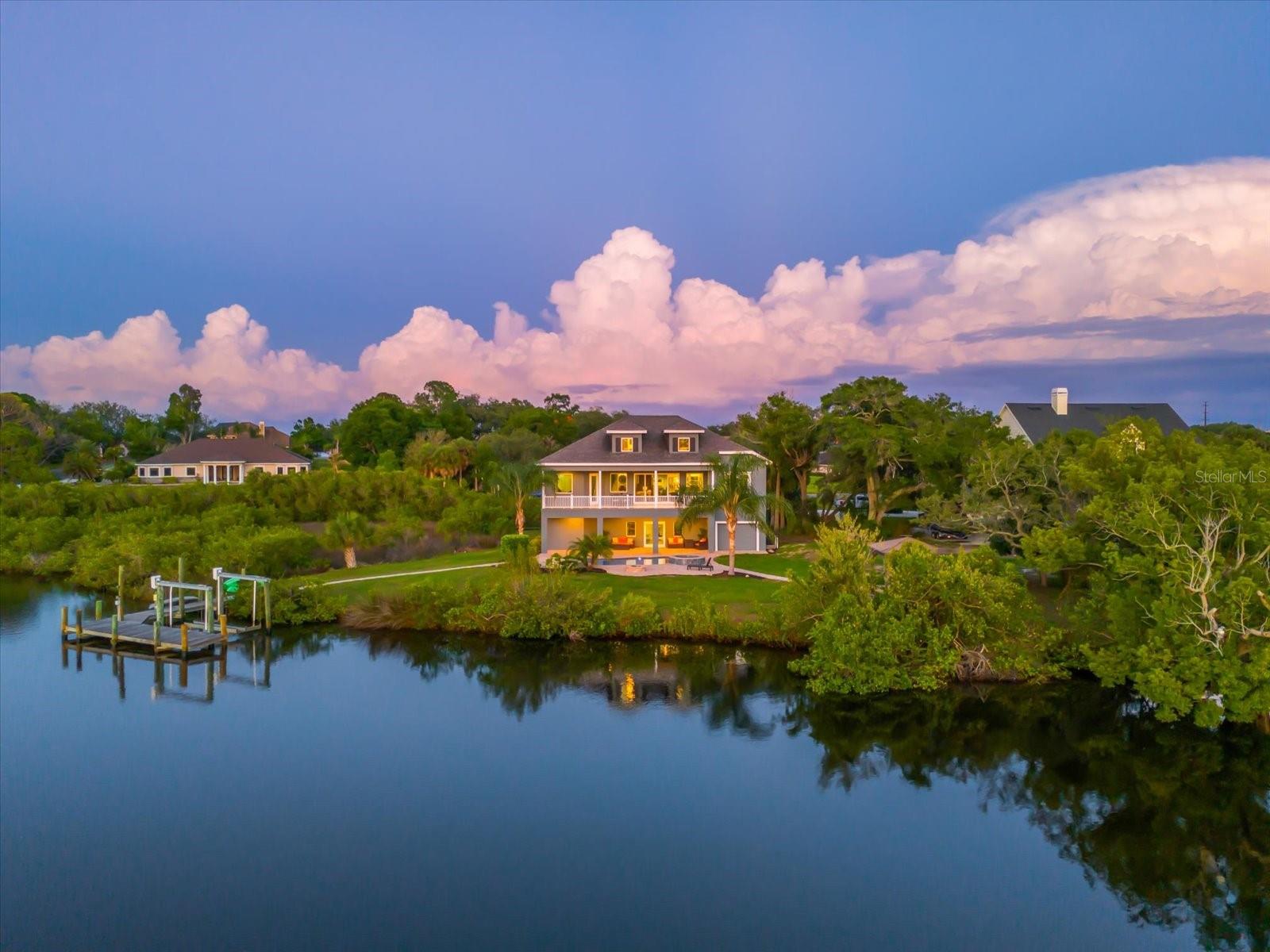 Welcome to an exceptional waterfront estate offering a rare blend of privacy, acreage, and riverfront living in one of Tarpon Springs' most desirable settings. Nestled on approximately 2.88 acres encompassing 125,522 square feet, this remarkable property captures the essence of Florida luxury with direct access to the Anclote River, the Gulf of America as well as Salt Lake - enjoy scenic water views, and an extraordinary outdoor lifestyle.

Constructed in 2017, the residence spans 2,891 heated square feet and 5,741 total square feet, thoughtfully designed to maximize comfort, functionality, and connection to its natural surroundings. The home features 4 bedrooms, 3 full bathrooms, 1 half bathroom, a dedicated office, and a versatile bonus room, providing flexibility for both everyday living and entertaining.

The open-concept design is enhanced by tray ceilings, abundant natural light, spacious gathering areas, solid-surface countertops, and quality finishes throughout. The well-appointed kitchen offers a built-in oven, cooktop, microwave, dishwasher, disposal, and generous preparation space, creating an ideal environment for hosting and daily living alike.

The primary suite is conveniently situated on the main living level, while additional bedrooms and flexible-use spaces accommodate guests, remote work, hobbies, or recreation with ease.

Outdoor living is equally impressive. A heated chlorine-free pool and heated spa overlook the property's tranquil natural setting, creating a private retreat for relaxation and entertaining. Multiple outdoor gathering spaces, including a balcony, gazebo, fire pit area, and expansive yard, provide endless opportunities to enjoy Florida's year-round waterfront lifestyle.

For boating enthusiasts, the property offers direct river frontage, a private wooden dock, 10,000 lb lift and access to the Gulf of America allowing for effortless days on the water and unforgettable sunset cruises. Additionally family’s can enjoy wakeboarding, tubing, fishing, paddle-boarding, jet skiing and cruising on your boat or watercraft. The Gulf Beaches!

Additional highlights include an oversized 4+ car garage, mature landscaping, a conservation-inspired setting, public water service, and septic. While free from traditional HOA restrictions, the property benefits from the stability and character of an established master-planned community setting.

Combining modern construction, waterfront access, expansive acreage, and exceptional privacy, this is a rare opportunity to own a truly distinctive waterfront estate in the heart of Tarpon Springs.