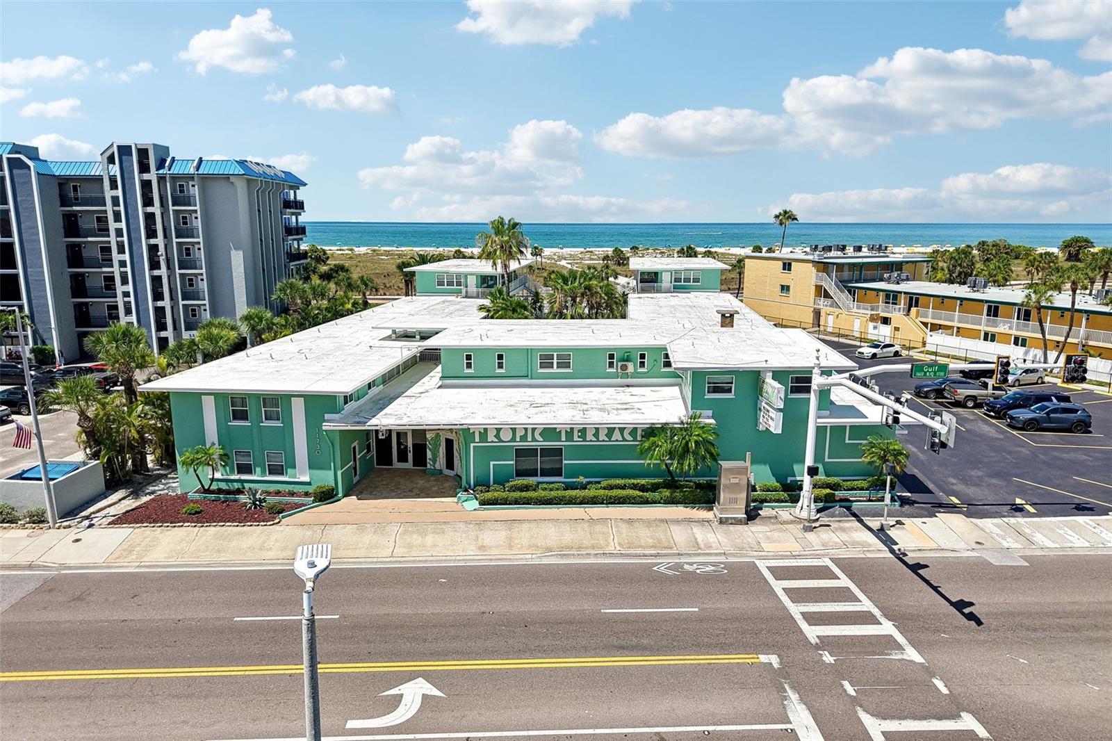 WELCOME TO PARADISE! Step into your dream beach lifestyle with this rare, retro coastal-chic, 2-bedroom, 1-bathroom, fully furnished, turn-key condo in the highly desirable Tropic Terrace community, situated directly on the Treasure Island Beach Boardwalk. This bright and airy second-floor corner unit sits "high and dry," offering open-concept living, pool views, two dining spaces, and a spacious primary suite with 2 closets, alongside a fully equipped kitchen featuring solid wood cabinetry, stainless steel appliances, and granite countertops. The Primary bedroom has 2 closets, one is designated for the owner, if the owner prefers to keep personal items locked up in the condo, and one for renting guests. There is also a locker for the owner in the primary storage room adjacent to the recreational room. No detail has been overlooked, with the owners investing $17,000 into a stunning, complete bathroom renovation in 2024, followed by a $1,500 refresh in 2025 that included fresh interior paint and three new, stylish ceiling light fixtures. The resort-style building itself has been beautifully updated with a brand-new pool, a redone main electrical conduit to all units, fresh exterior paint and outdoor flooring, and brand-new washers and dryers in the laundry room. This versatile property is zoned for 2-night minimum rentals and features on-site management for effortless income, though it can also be enjoyed as a relaxing getaway or a full-time residence. Exceptional value and convenience are built right in, as the condo fees seamlessly cover everything—electricity, water, sewer, trash, cable, internet, and access to resort amenities like shuffleboard, picnic tables with grills, a newly renovated indoor game room, and the sparkling pool. Complete with two coveted on-site parking passes, this boutique beachfront retreat places you just steps from the pristine sands of the Gulf of Mexico, world-renowned sunsets, and vibrant local restaurants, shops, and premier events like Sanding Ovations and the Treasure Island Kite Festival. Grab your beach bag and start living the dream from day one!