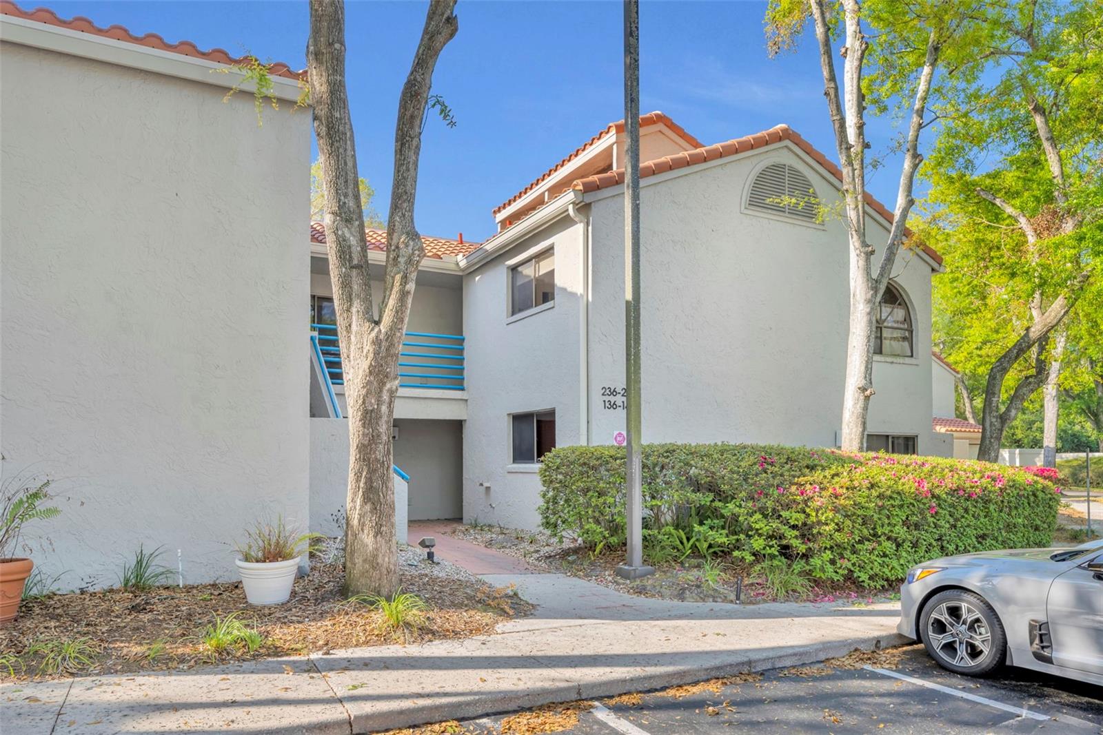 Elegantly renovated two-bedroom, two-bath second-floor condo in the gated community of Sun Bay Club on Lake Destiny in Maitland. Vaulted ceilings and abundant windows create a bright, airy atmosphere throughout. The gourmet kitchen has been fully updated with 42-inch custom hardwood cabinets, Zodiaq (Cambrian) quartz countertops, a Kohler farmhouse sink, stainless steel appliances, and porcelain wood-plank floors. The kitchen opens to the dining and living areas, featuring a built-in desk, wood-burning fireplace, custom built-ins, clerestory windows, and triple sliding doors leading to a private balcony with a storage closet. The split floorplan includes the primary suite with a walk-in closet and a renovated bath with dual vanities, hardwood cabinets, designer fixtures, a glass-block shower, and natural light from a private skylight. The secondary bedroom has two wall closets and an upgraded bathroom with custom cabinets, a tub, and a skylight. Meticulously maintained with pride of ownership reflected throughout. Features include double-door entry, knockdown ceilings, designer finishes, ample storage, and an interior laundry closet. Additional updates include a new Carrier AC (2023), a new hot water heater (2025), and a new tile roof with gutters, downspouts, and skylights (2024). Sun Bay Club offers a beautiful lakefront pool, lake access with a boat ramp, a tennis court, a dog park, a community meeting room, and a car wash area for residents. Its central location is just minutes from I-4, RDV Sportsplex, Publix, shopping, and dining. Downtown Maitland, Winter Park, and Orlando are only a short drive away.