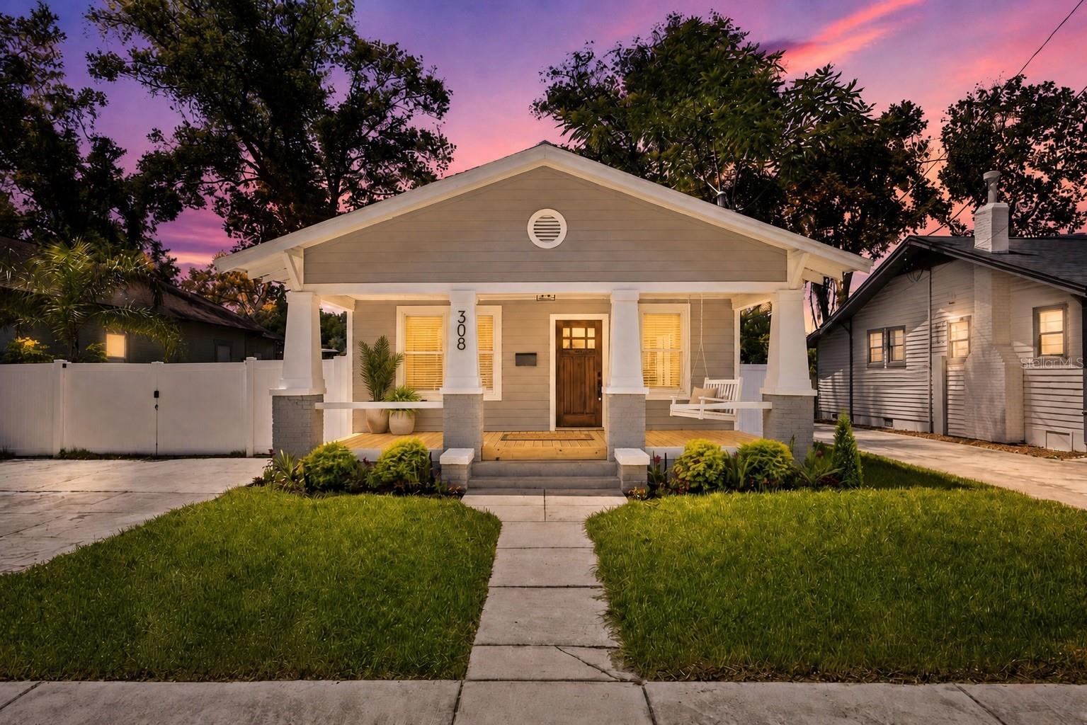 Welcome to 308 W. Alfred Street in the heart of Tampa Heights, where timeless character meets exceptional craftsmanship in this fully gutted and meticulously renovated 4-bedroom, 3-bathroom home. This home sits on a massive lot and every detail has been thoughtfully redesigned, creating a truly turnkey residence that offers the charm of a historic home with the peace of mind of virtually new construction. From the moment you arrive, you'll appreciate the stunning curb appeal featuring all-new Hardie Plank siding, fresh landscaping, a new irrigation system, a welcoming reconfigured front porch, a beautifully refinished original mahogany front door, and a brand-new white vinyl privacy fence. Set on a spacious lot with a large backyard, the home also features an expansive rear deck, creating the perfect setting for entertaining, relaxing, or enjoying Florida's beautiful weather. No expense was spared during the renovation. Structural improvements include significant new roof decking, a brand-new roof backed by a 30-year warranty, partial new framing, foundation repairs with leveled floors, new wall and attic insulation, all-new exterior sheathing, and a complete weather-resistant house wrap. The home has also been fully tented and trenched for termites, with an assignable warranty available for continued peace of mind. Inside, you'll find a bright, open layout highlighted by beautifully refinished original hardwood floors on the main level and new engineered hardwood flooring in the primary suite. Every major system has been replaced, including new plumbing, electrical, HVAC ductwork, lighting, water heater, and all interior doors with updated hardware, ensuring years of worry-free ownership. The chef-inspired kitchen is the centerpiece of the home, showcasing custom cabinetry, stunning multi-slab Taj Mahal quartzite countertops, brand-new stainless steel appliances, and abundant workspace designed for both everyday living and entertaining. The spacious primary suite has been completely reimagined with two custom closets and a luxurious spa-like bathroom featuring large-format porcelain tile, premium finishes, and a thoughtfully designed layout. The secondary bathrooms have also been beautifully updated, including elegant marble flooring in one bath and the laundry room. Homes offering this level of renovation are incredibly rare. With virtually every major component replaced—from the structure and systems to the designer finishes, 308 W. Alfred Street delivers the perfect combination of classic character, modern luxury, and long-term peace of mind, all situated on a generous homesite with ample outdoor living space. This is truly a move-in-ready home where every detail has already been done for you. Just minutes to everything the city has to offer!