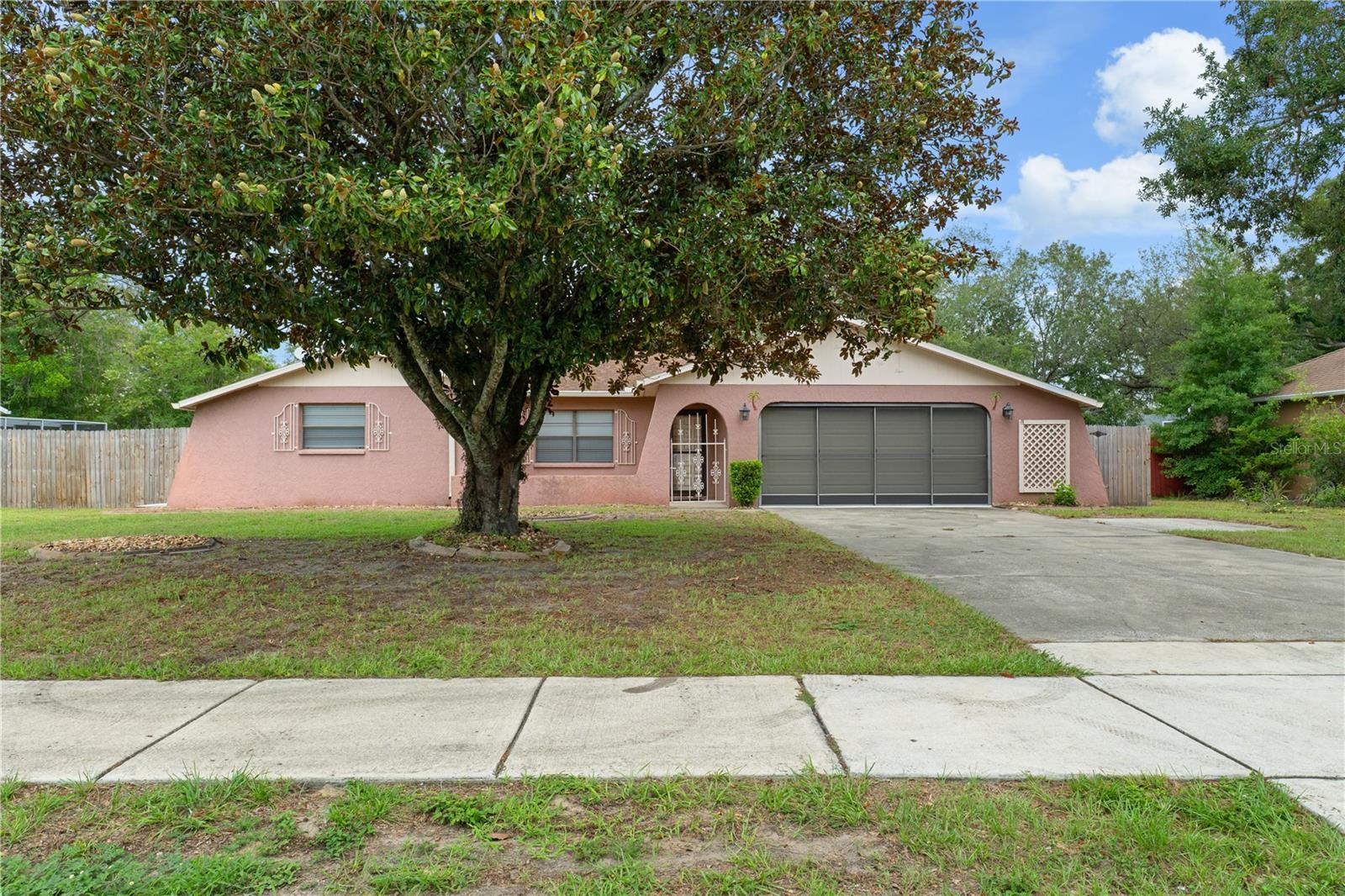 Move-in ready Florida pool home -- 2 bed, 2 bath, 2-car garage, and fenced yard. Enjoy effortless Florida living in this beautifully refreshed single-story home featuring an open floor plan and light-filled living spaces. Recent updates include fresh interior paint, new flooring throughout the living area and bedrooms, and new bathroom vanities. The open kitchen flows seamlessly to the dining and living areas - perfect for entertaining. The primary suite offers privacy plus a slider that opens directly to the pool area for easy indoor-outdoor access. Outside, relax on the paver brick deck or entertain in the fenced backyard with a sparkling pool. Hurry up and come get your piece of the Florida Lifestyle and enjoy your mornings poolside!!!