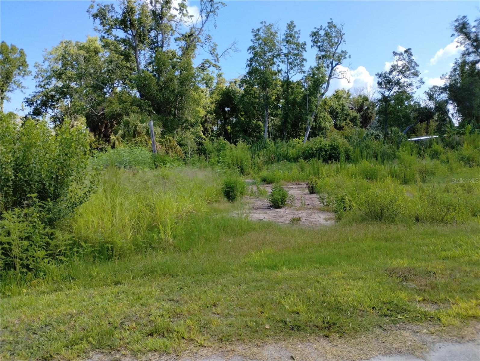Build your dream home in Gulf Side Estates on this cleared, build-ready lot. Public water and sewer are available, with connection fees applicable. An eletrical pole is already on-site; service connection and related fees may apply. The property includes a 7-foot easement on each side and a 15-foot rear easement near the wetlands. Ideally situated near US Hwy 19, this location offers convenient access to shopping, dining and everyday amenities.