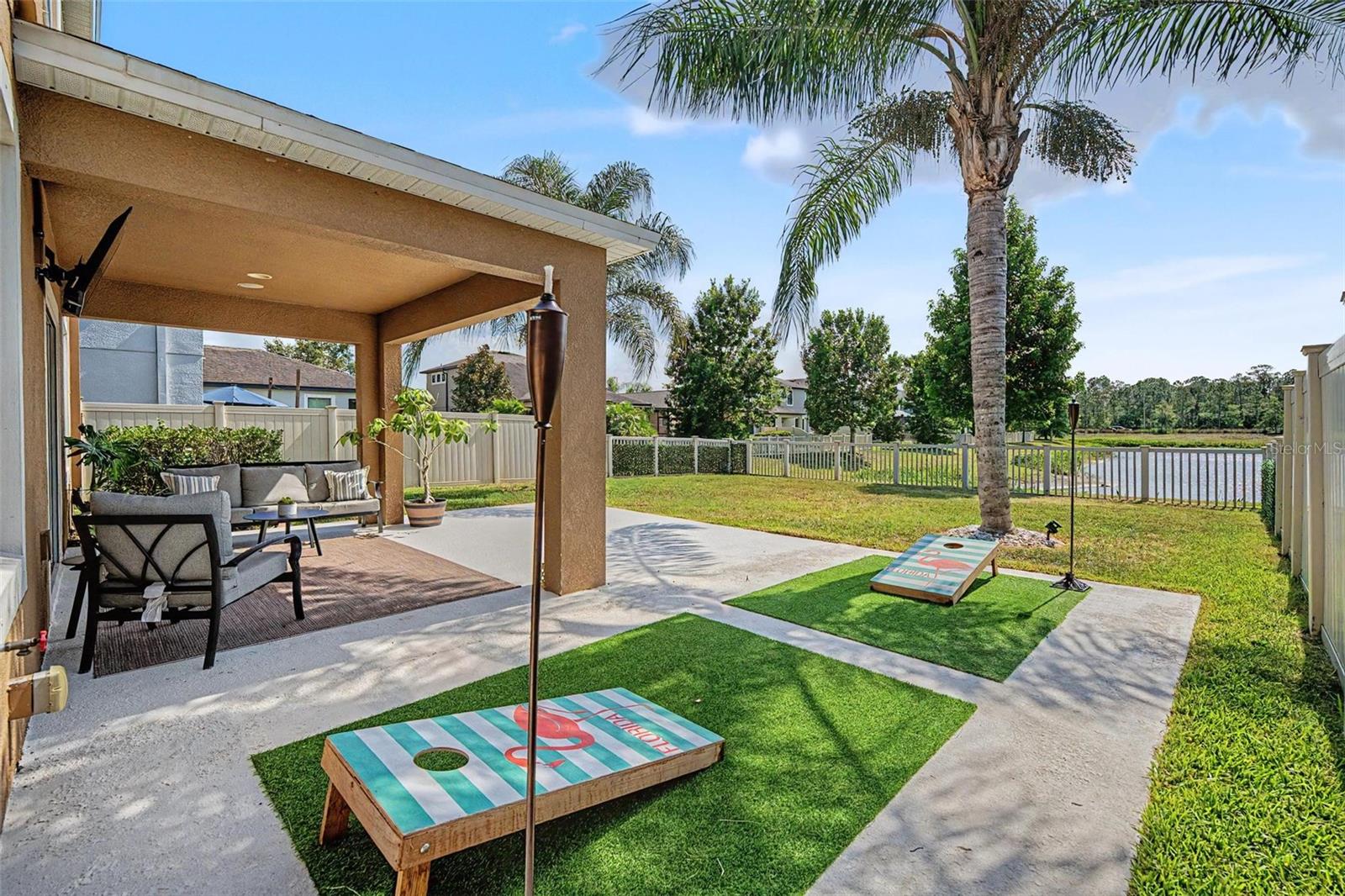 Welcome to this beautifully maintained WATERFRONT home in the highly desirable LONG LAKE RANCH. This home is WALKABLE to community amenities including dog park, pool, playground, basketball courts and tennis.  This home has an open floorplan, where peaceful views and everyday comfort come together. With no rear neighbors and a large, fully fenced backyard overlooking the water, you'll have the perfect setting for entertaining, relaxing, letting pets roam, or enjoying family time outdoors. When you enter through the custom glass front doors, Inside you will find plantation shutters throughout that are a huge plus, while the light-filled open-concept floor plan creates an inviting atmosphere ideal for both everyday living and hosting guests. The main living area has a sliding glass door leading to the covered patio and pond views, the perfect place to start or end your day. The well-appointed kitchen is truly the heart of the home, featuring white 48 inch cabinets, a spacious center island, granite countertops, tall cabinetry, stainless steel appliances, and plenty of room to gather. Thoughtful touches include built-in surround sound, easy-care wood tile, stylish light fixtures and ceiling fans, enhancing the home's appeal. Upstairs, retreat to the generous primary suite, complete with a comfortable sitting area perfectly positioned to capture tranquil water views. The en-suite bath offers a water closet, dual granite vanities, a relaxing garden tub, and a large walk-in closet designed to accommodate your lifestyle. Three additional bedrooms provide flexible space for family, guests, a home office, or hobbies. This beautiful community boasts acres of conservation and wetlands. At its heart is a 40 acre lake where residents can enjoy the dock or walk around the pond and take in the views! Amenities include a resort style pool with splash zone, tennis and basketball courts, multiple picnic areas with tables and grills, dog park and playgrounds. A second pool with cabana is located in the townhome neighborhood, so plenty of room for everyone!