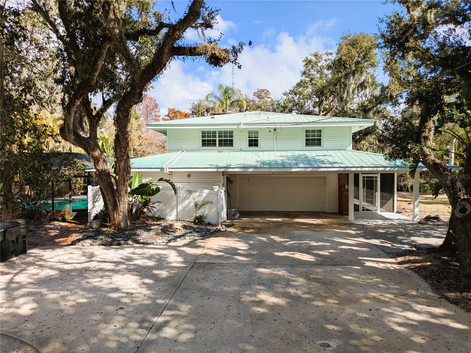 Rare 3.2-acre private pool estate in Sarasota featuring a main residence and separate updated guest home—all set against tranquil pond views and lush, professionally designed landscaping. Accessed by a private road, this exceptional property offers complete privacy, multiple dwellings, and extraordinary flexibility for multigenerational living, rental income, recreation, or future development.

Despite its peaceful, secluded setting, the estate is just minutes from Sarasota’s world-renowned beaches, vibrant downtown, premier shopping and dining, top-rated hospitals, parks, and the airport. Opportunities to own this level of acreage, privacy, and versatility in such a prime location are exceedingly rare. 2 car garage, carport and outbuilding included. Low taxes. No HOA. Sarasota County just outside city limits.