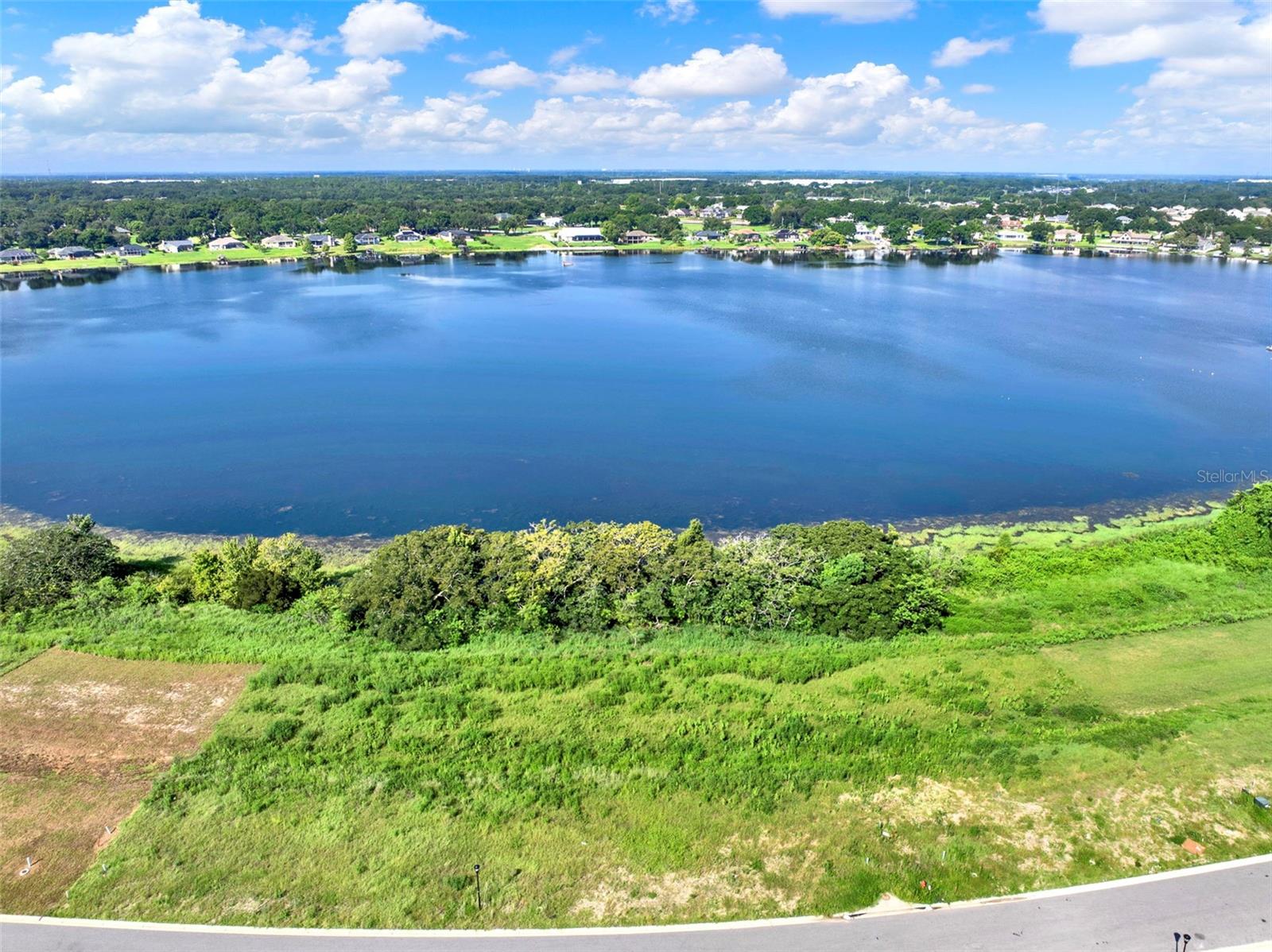 Build the home of your dreams on this exceptional lakefront lot offering direct shoreline on beautiful Lake Tennessee. Nestled within the
prestigious, gated community of Lake Juliana Estates, this cleared lot is ready for your vision—offering panoramic water views and access to a
serene 108-acre public lake ideal for boating, fishing, water skiing, and more. Residents of Lake Juliana Estates enjoy exclusive, resort-style
amenities including a clubhouse, fitness center, tennis and pickleball courts, and a private community boat ramp to Lake Juliana. Conveniently
located near I-4, this prime location provides easy access to both Orlando and Tampa. Don’t miss the chance to own a slice of lakefront paradise in one of Central Florida’s most desirable communities!