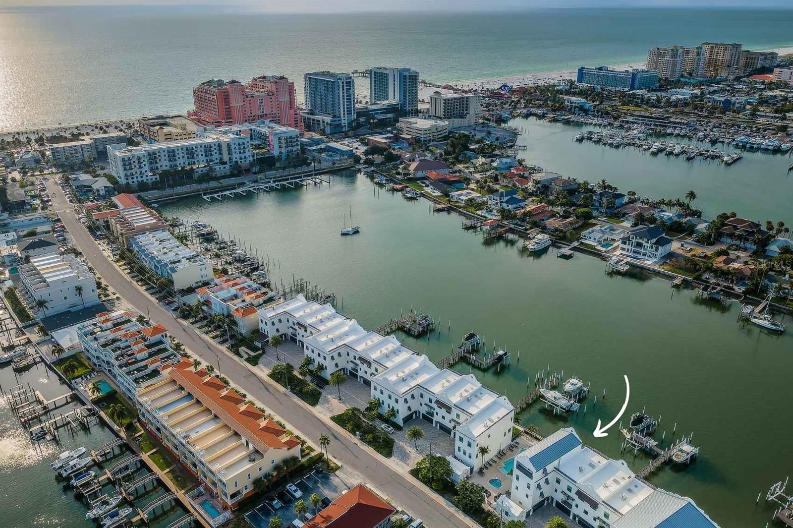 A masterful achievement of concept and design, this 4-story coastal contemporary waterfront residence showcases exquisite
craftsmanship, seamlessly integrated indoor/outdoor living with floor-to-ceiling glass sliding doors, luminous open spaces, 3 terraces, direct
Clearwater Bay views from most every room, adjacent to the Brightwater Blue pool, heated spa & grills. DEEDED boat slip and dock, 9,000 lb lift,
water & electric! Ground level bonus room, ELEVATOR stops at all 4 floors & 2-car garage is perfect for any family, an entertainer's delight! 4x
glass slider opens onto the covered porch patio & grassy backyard. Conducive to today's lifestyle this culinary kitchen offers - stainless
appliances, white Shaker cabinetry, platinum pulls, crown molding, quartz tops, work center, wall pantry with pull-out drawers, glass front
storage cabinetry. Utility laundry room. Powder room. Dining room will seat 8 comfortably: chandelier. Relax and unwind in the great room which
overlooks the Bay. Open the 4x glass sliding doors to the covered terrace, ceiling fan, v-groove ceiling, slate floors & remote screen shades.
Spectacular waterfront views! 3rd floor: 3 bedrooms: waterfront bedroom - walk-in closet, crown molding, chandelier, TV, & private covered
balcony. Bath en-suite: tub & walk-in shower, 2-sink quartz vanity, separate H20 closet. The additional 2-guests bedrooms: chandelier, closet &
TV. Guest bath: glass door walk-in shower, quartz top vanity. 4th floor: Master bedroom: crown molding, chandelier, TV, covered patio overlooks
Clearwater Bay. Sumptuous master bath: 2-sink quartz top vanity, soaking tub, glass door walk-in shower, H20 closet, his & hers walk-in custom
closets! This townhome construction is poured concrete slabs, impact glass doors & windows, 10' ceilings, solid core 8' doors, luxury vinyl floors.
Nest thermostats, part-time security guard, a short 2-block walk to the Gulf of Mexico!