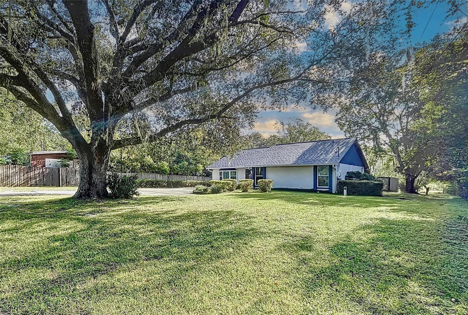 A LITTLE BIT COUNTRY!  OVER 2 ACRES of Land zone AR with a private pond.  This home has 3 Bedrooms, 2 Baths plus a work from home Office/Den.  Split Bedroom Plan and the Master offers a walk-in closet. The Kitchen has been updated with Sleek Quartz Counter tops, country Cabinets with Glass Fronts and a Wine Cooler.  Dining Area is located just off the kitchen. The Open Family Room offers a beautiful vista of the Back Yard through the French Doors.  You'll want to enjoy your morning coffee or evening beverage on the Breezy Screened Lanai while you ENJOY NATURE while you watch the Deer & Wild Turkeys coming in and out of the woods to drink at your private POND. The AR Zoning allows for Horses or grazing animals and there are no deed restrictions.  Large Yard with Electronic Gate. Extras Include: Hurricane French Doors and Windows that were updated in 2020, AC was New in 2022, New Roof 2021 and front Gutters in 2023.  Large Storage Building (approximately 14 x 20 in as-is condition but it's a keeper!), RV Cover, Fema Letter in Attachments shows No Mandatory Flood Insurance, HUGE lanai approximately 20 X 40, convenient Interior Laundry / Mud Room. The back of the lot is heavily wooded and Nature Abounds.