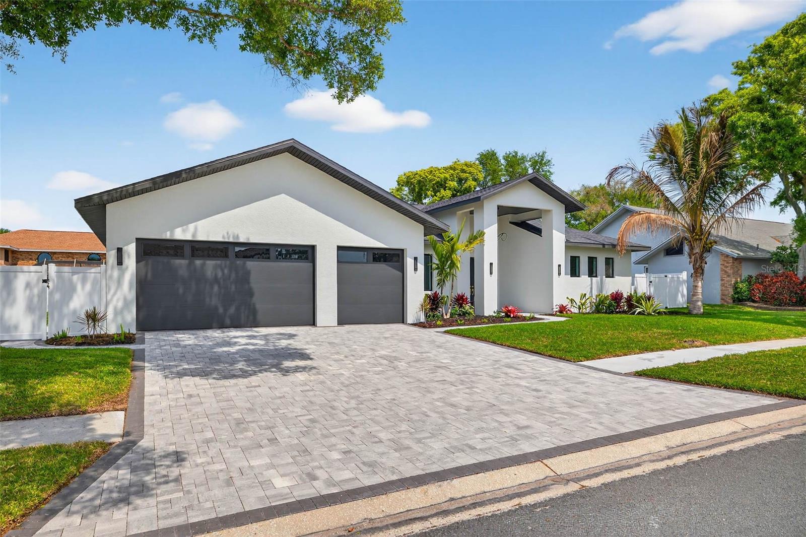 WOW, Fantastic New Price!!!! Welcome to 14447 Mark Drive Largo! Brand-new construction in the highly desirable Collins Estates neighborhood of Largo, Florida—this exceptional 5,000+ square foot residence offers the perfect blend of luxury, functionality, and peace of mind, located in a non-evacuation flood zone. Designed with a spacious split floor plan, the home features four oversized bedrooms, including a true dual primary suite layout ideal for multi-generational living or extended guests, along with five full bathrooms and one half bath. Soaring 10-foot ceilings in all bedrooms and dramatic 16-foot vaulted ceilings in the main living areas—including the living room, family room, dining area, and rear primary suite—create a bright, open, and airy feel throughout. The chef’s kitchen is a standout, showcasing custom cabinetry, elegant Cambria countertops, and seamless flow into the living spaces, while a convenient butler’s pantry and combined laundry room connect directly to the oversized three-car garage with epoxy-coated flooring and oversized doors. Large-format ceramic tile runs throughout the entire home for durability and easy maintenance, complemented by dual-zone AC systems for efficient climate control. Step outside to your private retreat featuring a custom saltwater pool with an attached cabana, surrounded by mature tropical landscaping for added privacy and curb appeal. Each bedroom includes expansive walk-in closets with the potential for custom build-outs to suit the buyer’s needs. This newly built home delivers high-end finishes, thoughtful design, and resort-style living in one of Largo’s most sought-after communities—perfectly suited for today’s modern lifestyle. Builder is offering a NEW HOME WARRANTY!