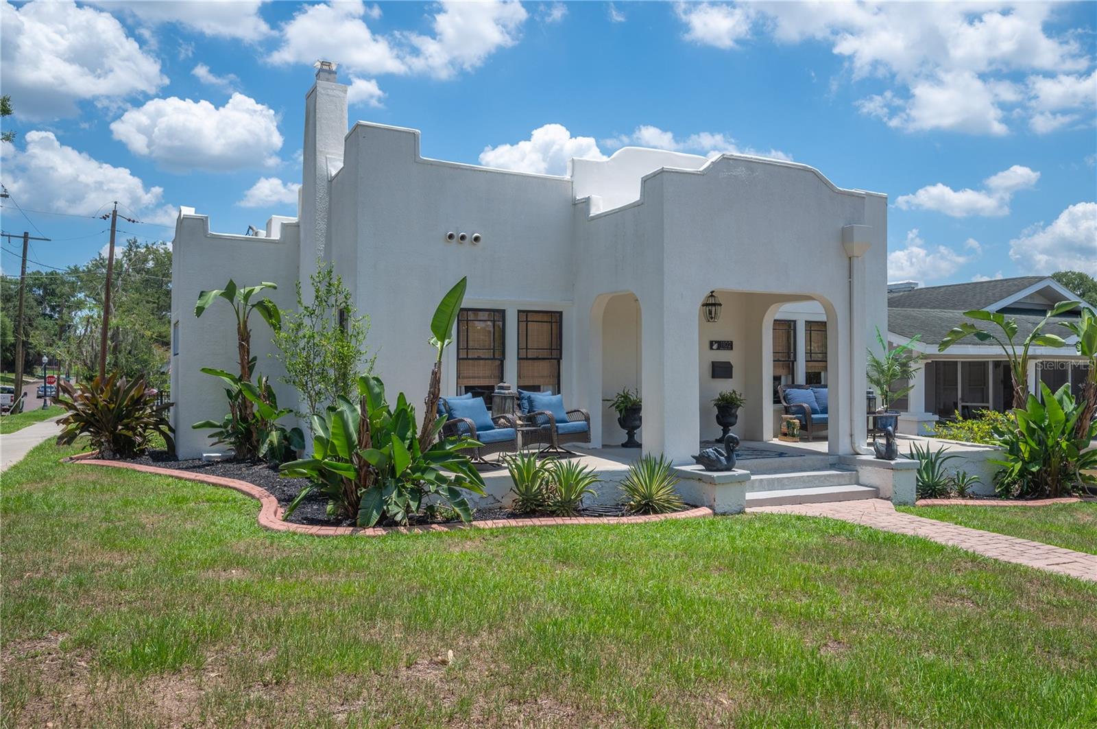 Mediterranean charm meets exceptional historic character in this beautifully preserved 1920s historic home nestled on a picturesque brick-lined street in the South Lake Morton Historic District! Situated on a prominent corner lot, this rare property offers views of Lake Hollingsworth from the welcoming front porch and includes a detached studio apartment above an oversized two-car garage. The main house features 3 bedrooms, 2 bathrooms, and 1,396 sq. ft. of living space. Original details tell the story of the home's rich history, including log cabin-style oak flooring, picture rail molding in the living room, recently refurbished historic windows, original interior doors, and a vintage tile bathroom that beautifully reflects the home's architectural heritage. Adding flexibility and value, the detached 580-square-foot studio apartment features an open-concept design complete with a full kitchen, eat-in bar, full bathroom, and a designated space for a bedroom with closets —ideal for guests, extended family, a private office, creative studio, or rental income opportunity! The property has been maintained and updated with a 2019 roof, 2022 HVAC system for the main home, 2024 central air system for the apartment, a mini-split AC system in the garage, and gas water heater installed in 2022! Enjoy one of Lakeland's most desirable historic neighborhoods with convenient access to both Lake Hollingsworth and Lake Morton, as well as beloved local destinations including Cob & Pen Eatery, Born & Bread Bakehouse, Peach House, and the Lakeland Public Library. This is a rare opportunity to own a piece of Lakeland history in a location that beautifully blends architectural character, modern updates, and the best of Lakeland living!