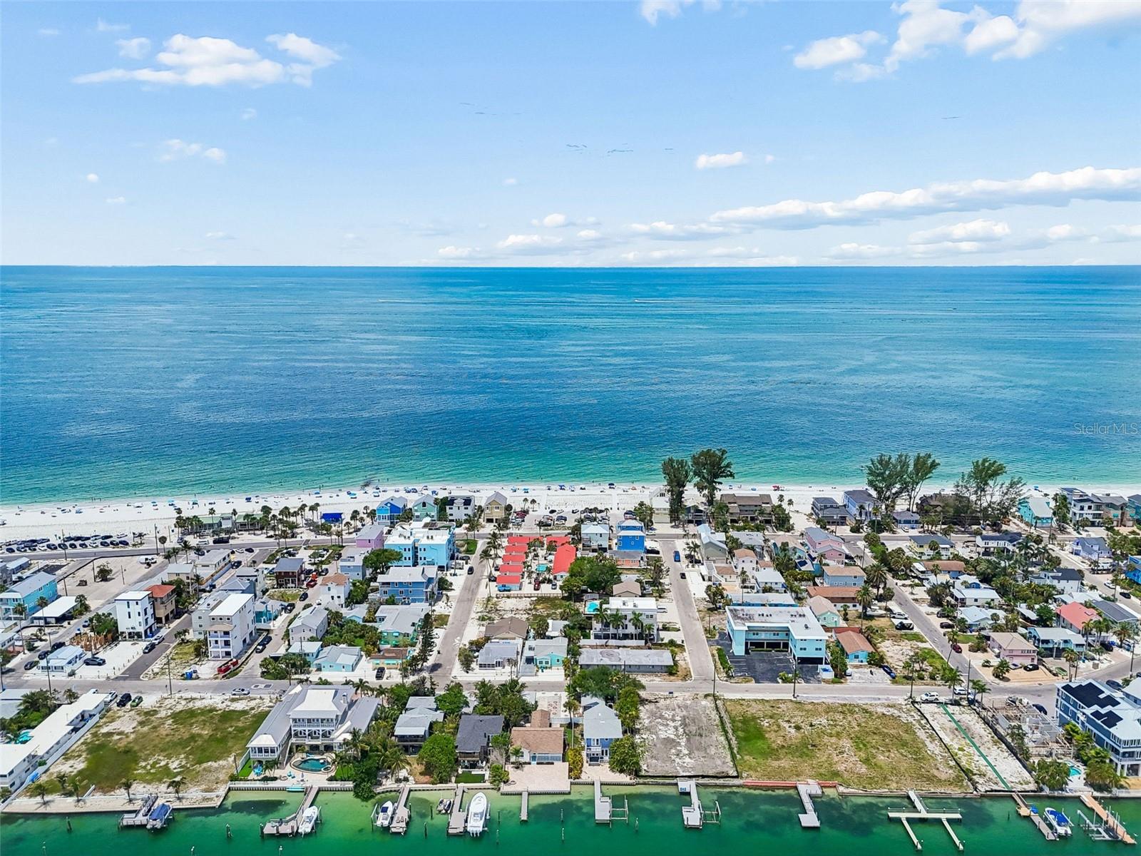 GOT A BIG BOAT? True Island Living at its Best! This waterfront home is located right on the Intracoastal Waterway with deep water  access through the pass to the Gulf of Mexico within minutes, PLUS, you're just steps from the beautiful Gulf Beaches on the island. Recently remodeled from top to bottom with a coastal flair. Spacious 2 bedroom 2 bath floor plan, practical kitchen layout with eat at bar and a dining area, pantry closet, inside laundry area and north and south courtyards with access from bonus/office/studio room. Large waterside covered porch with a huge paver gathering area and fire pit, a composite boat dock w/water/electric,( Planned is a new 50' composite dock with 8'x20' head, 16000# lift, 2-place pwr. waverunner lift, currently under construction review.) the home has a newer seawall and quaint fenced relaxing areas with tropical plantings, turf and pavers. Sunset Beach is Golf Cart friendly and offers some of the best sandy beaches in South Florida which are just steps from your back door. Entertainment, dining, boat ramp, beach pavilion, playground and boardwalk are an easy walk, bike or golf cart ride. This Beautiful Island home has a private garage with door opener, storage and huge off street parking in the rear. Offered unfurnished as a yearly long-term lease. (Includes grounds maintenance) Don’t miss out on one of Pinellas Counties’ hottest beach areas to live! (A TRUE BOATER'S DREAM HOME)