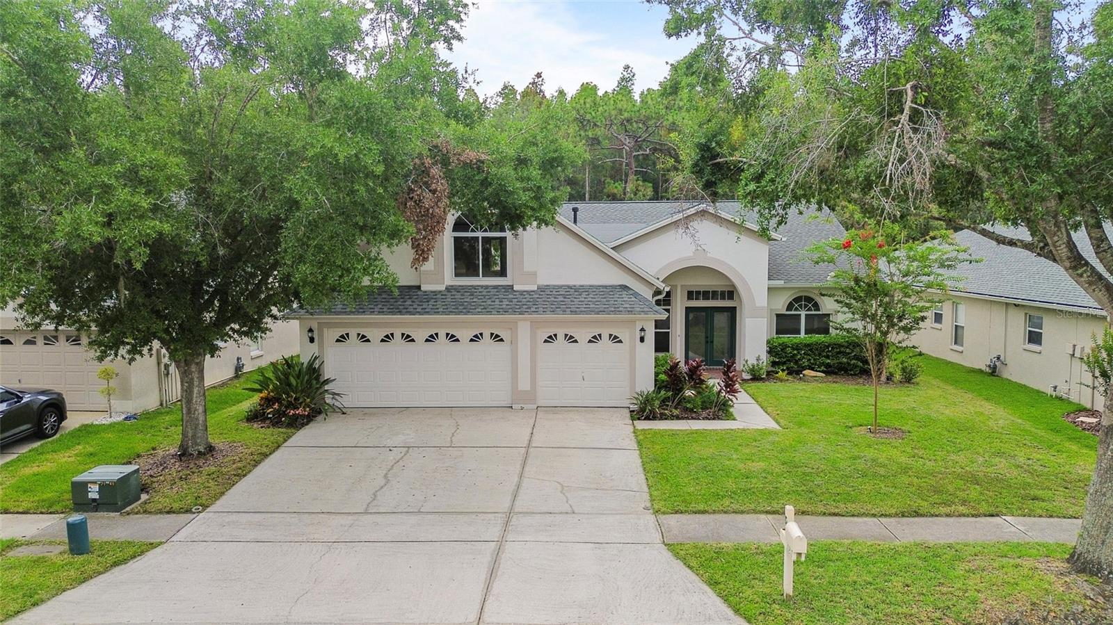Fully remodeled in 2025 and move-in ready! This spacious 5-bedroom, 3-bath home with a 3-car garage features soaring ceilings, an open-concept floor plan, and a desirable triple-split bedroom layout. Backing to a private conservation area with no rear neighbors, this home offers both tranquility and privacy. Major updates include a new roof in 2019 and a complete interior renovation in 2025. Located in the highly sought-after Arbor Greene community, residents enjoy resort-style amenities including a clubhouse, pool, tennis courts, pickleball courts, fitness center, and more. Conveniently situated near top-rated schools, shopping, dining, grocery stores, Wiregrass Mall, hospitals, parks, and major highways. Just 20 minutes to Busch Gardens, 30 minutes to Tampa International Airport, and approximately one hour to Disney World. Don't miss this exceptional opportunity to own a beautifully updated home in one of Tampa's premier gated communities!