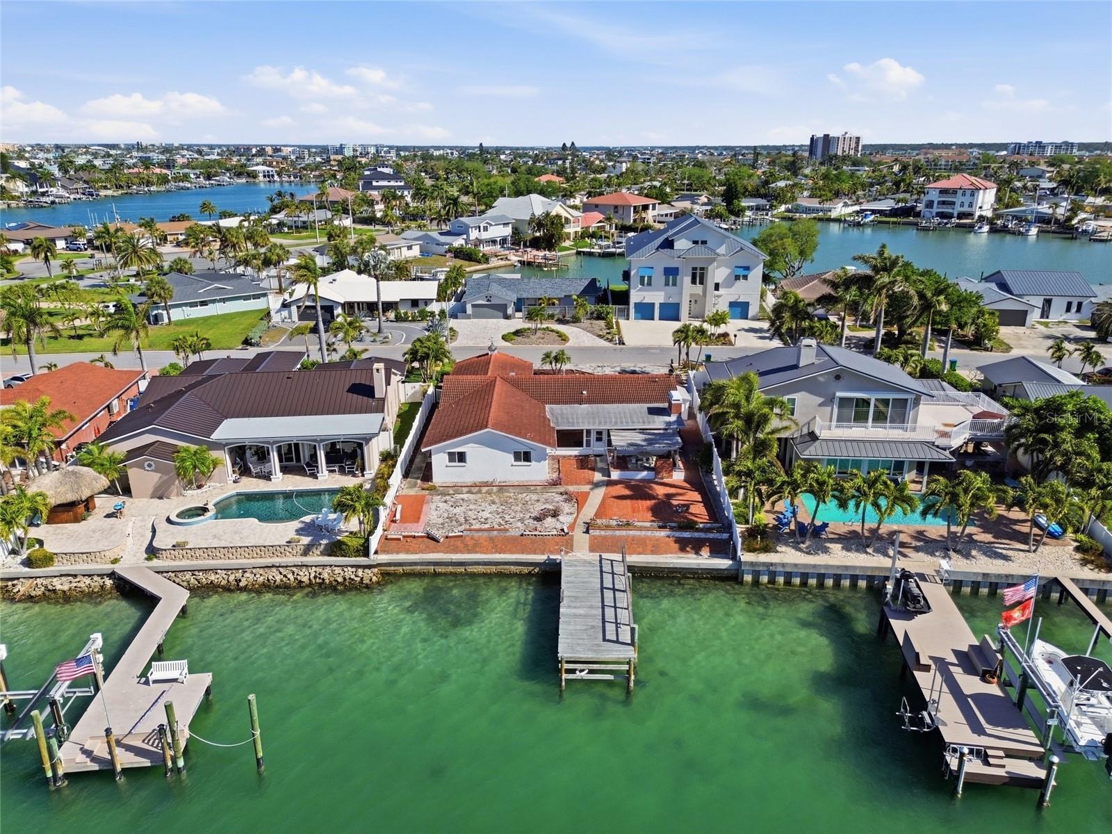 Located on a quiet cul-de-sac on Paradise Island, this 9,518 SF waterfront property with 73-feet of frontage looks south onto Devil’s Elbow with only one bridge to the Gulf. Constructed as a 2,409 SF 4-bedroom, 2-bath home, the property had 6-inches of water affect floors, drywall and electrical after hurricane in 2024 and can either be demolished or considered a rebuildable structure to build your dream home (existing neighbors have done both). Paradise Island is a highly desirable residential neighborhood known for friendly residents, convenience and tropical charm. Just minutes from the sandy beaches of Treasure Island as well as downtown St. Petersburg with its ongoing cultural events, sports and restaurants. And close by, Treasure Bay Golf & Tennis offers scenic views of Boca Ciega Bay, pickleball, tennis, a par-3 golf course (temporarily closed for an environmental study) and playgrounds—a beautiful intracoastal resource to enhance family living in Paradise Island.  Priced under 2025 appraised value. The value is in the land.