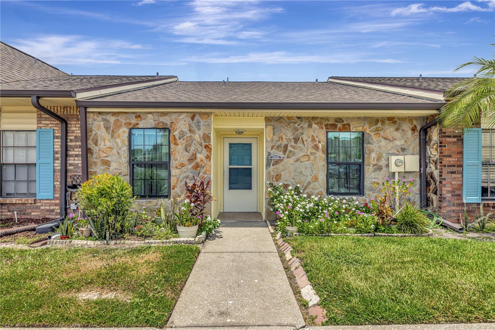 Prime Location Alert! Don't miss out on this beautiful 2-bedroom, 2-bathroom townhouse featuring vaulted ceilings, new paint, new planked Luxury Vinyl flooring in common areas along with porcelain and ceramic tile in bedrooms and bathrooms and hurricane impact rated windows.  Primary suite has an ensuite bath with an upgraded shower and sliders that leads to a courtyard style back yard. The second bedroom is separate from the primary and provides privacy in this split-floor plan townhome. The roof is just over 4 years old. Additional highlights include an inside laundry closet, assigned parking (two spaces) and guest parking. The HOA fee of $360/month includes water, sewer, trash, exterior maintenance, community pool access, and more, providing excellent value and low-maintenance living.  Take advantage of its close proximity to shopping, dining, Tampa Airport, Busch Gardens, and Downtown Tampa. Experience the best of Tampa living in this beautiful home!