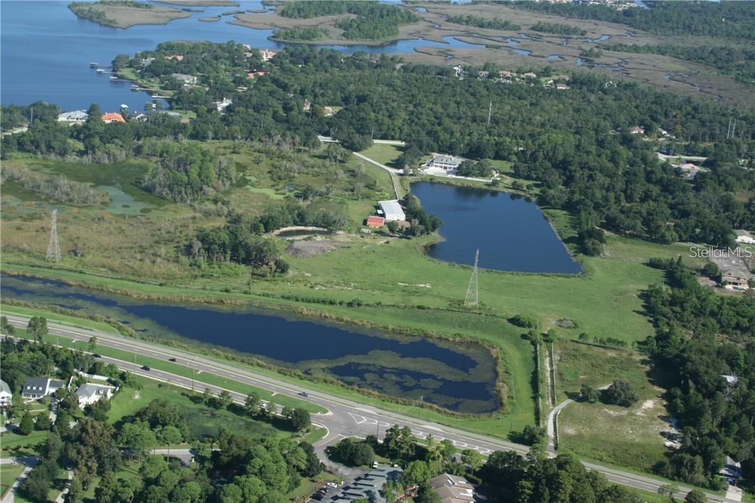 Rare opportunity for acreage in north Pinellas county!!!! 45 acres (MOL) located just north of Lake Tarpon in Tarpon Springs has boundary fencing, an 8 acre private lake and 6,250 square foot metal barn that can hold all  our toys and/or animals. Property can be accessed from N. Highland Ave or Keystone Rd.  Total seclusion, private compound, prime acreage with location, location, location!!