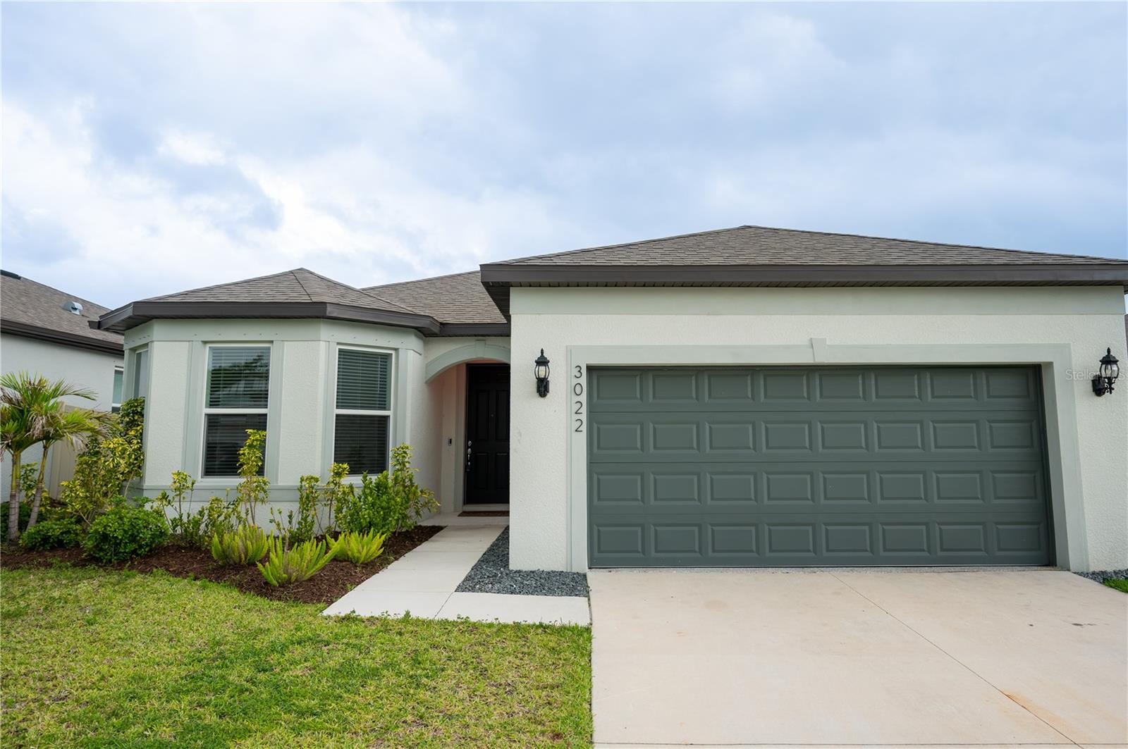 Welcome to this stunning newer-construction home in the desirable Marwood community of Ellenton. Built in 2024, this beautifully designed Medina floor plan offers over 2,200 square feet of thoughtfully crafted living space with 3 bedrooms, 3 bathrooms, and a versatile flex room perfect for a home office, den, or guest space.  Step inside to discover an open-concept layout filled with natural light, stylish tile flooring throughout the main living areas, and elegant finishes at every turn. The chef-inspired kitchen features quartz countertops, white cabinetry, stainless steel appliances, a spacious center island, and designer backsplash details ideal for entertaining or everyday living. The expansive owner’s suite offers a spa-like bath with dual vanities, a walk-in shower, private water closet, and generous walk-in closet.  Enjoy seamless indoor-outdoor living with an extended gathering room that opens to a covered lanai overlooking the landscaped backyard. Additional highlights include a 2-car garage, smart home technology package, hurricane shutters, energy-efficient features, and low HOA fees with no CDD fees. Conveniently located less than a mile from I-75 and close to shopping, dining, and the Ellenton Premium Outlets, this home combines modern comfort with exceptional convenience.