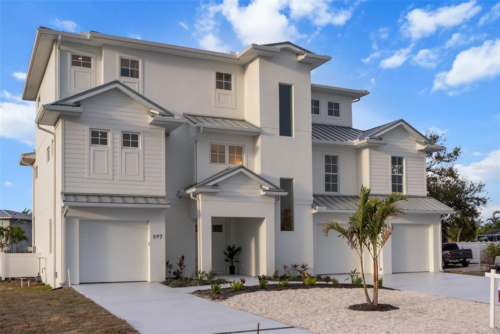 New Construction....   GULF AND BAY VIEWS! THREE OUTDOOR PATIOS! Discover an extraordinary coastal contemporary masterpiece by Floridian Crafted Homes, perfectly positioned on Longboat Key with breathtaking Gulf and Bay views. This 13 FEET ELEVATED, hurricane-fortified residence offers 5 bedrooms, 5 full bathrooms, and 2 partial bathrooms across 4,176 square feet of luxurious living space. Home has elevator shaft blocked in and ready to receive elevator mechanics. Designed for both elegance and functionality, this home features three expansive outdoor living spaces, including two private balconies and a stunning rooftop deck, perfect for capturing the serene Gulf sunsets. The open-concept great room flows effortlessly into the gourmet kitchen, creating an entertainer’s dream, while the second-floor club room offers a private retreat for relaxation. Outdoors, a private pool and spa provide a tranquil escape, while the 5+ car garage ensures ample storage for vehicles and beach essentials. Located just steps from the beach and steps to the upcoming retail and dining destination (Est. Fall 2025), this home also offers access to a community marina with available boat slips, making it ideal for boating enthusiasts. Experience the pinnacle of modern coastal luxury in this exceptional Longboat Key residence—where timeless design, breathtaking views, and an unparalleled location create the ultimate island retreat.