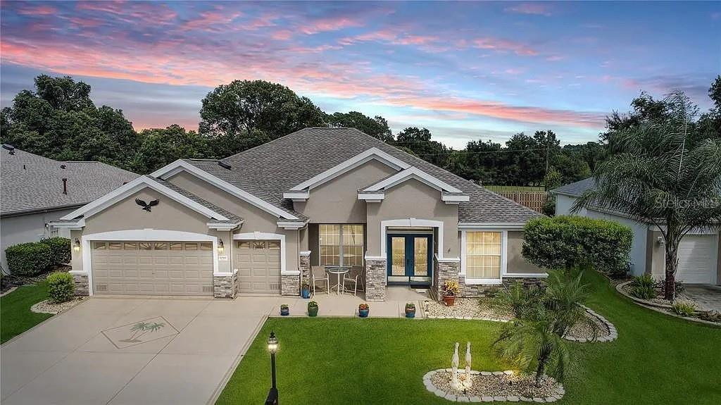 Executive styled home on a private lot in Wellington in Del Webb's Spruce Creek Golf & Country Club.  No close neighbors on the other side of the fence.  Great curb appeal.  Designer drive and walkway with façade brick to accentuate the total package.  Low maintenance landscaping.  Glass leaded double door entry into the foyer, formal living/dining rooms featuring wood-like tiles for easy maintenance with a slider to the lanai.  Open floor plan that flows effortlessly into the heart of the home.  Large gourmet kitchen with island and one-level breakfast bar, Quartz counter tops, back splash and stainless-steel appliances (2018), solar tube, LED lighting and so much more.  Adjacent family room with slider to the lanai and entry into the library.  The library has the same wood-like tiles, chair rail moldings and built-in storage.  The other two bedrooms and large bath that is accessible from one of the bedrooms and hallway are also accessible from this area.  Primary suite is on the other side of the home with double door entry, a large master en-suite bath with large walk-in shower, private water closet and clothes closet.  The primary suite features the same wood-like tiles with a slider to the lanai as well.  Inside laundry with storage and utility sink and washer & dryer (2018).  Lanai is enclosed and climate control with a mini split  (6/2024) and features acrylic windows with roller shades (2020) and carpeting on the floor.  Patio located from the enclosed lanai provides solitude and peace and quiet.  Great for grilling and enjoying the Florida lifestyle. Oversized 2-car garage plus golf cart bay, pull-down storage plus wall storage.  Windows in the garage doors for natural lighting plus key-less entry feature.   New roof, entire exterior re-painted and new stone façade on front of home (2020).  HVAC (2014).  Gas water heater (2022).  Re-piped (12/2021) Great home for entertaining visitors or a perfect “staycation” for year-round pampering.  Make it yours today.