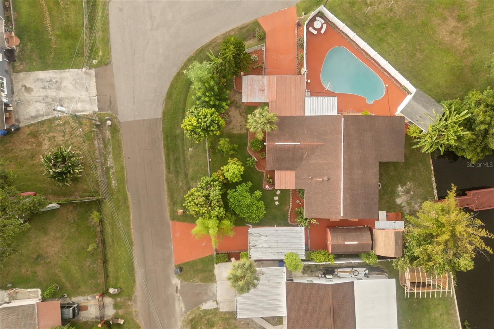Welcome to this beautifully maintained and completely remodeled 3-bedroom, 2-bath waterfront pool home with no HOA in the desirable Tricanal Estates of Tampa! Situated on a spacious corner lot, this one-of-a-kind property offers a great blend of modern updates, outdoor entertainment and Florida waterfront living. Extensively rebuilt and updated in 2024,  this home features block construction with all-new electrical, plumbing, drywall, interior and exterior paint, kitchen appliances, hot water heater and pool pump, providing peace of mind and true move-in-ready convenience. Inside, you'll find a bright and inviting floor plan featuring an oversized living room, dining area and a large Florida room overlooking the backyard oasis. The home offers 3 spacious bedrooms, including a primary suite with its own bath. Outdoor living is where this property truly shines. The backyard retreat features an in-ground pool with patio, custom poolside bar and serving area and a 20-foot pier/dock overlooking the lagoon and bird sanctuary with direct water access to Tampa Bay. A gardener's paradise, this property features an impressive collection of mature fruit trees and plants and bring your chickens as there is a chicken coop! Additional property highlights include: two large 12' x 20' storage sheds with electric, two driveways with covered carport parking and fresh interior and exterior paint. Conveniently located just minutes from major highways and roadways, this home provides easy access to Downtown Tampa, Brandon, Tampa International Airport, and Orlando, while still offering the seclusion and tranquility of waterfront living. This rare waterfront gem combines modern renovations, exceptional outdoor amenities, abundant gardening opportunities and direct bay access in 10 minutes, gulf access in 25 minutes - truly a unique Florida lifestyle property you won't want to miss!