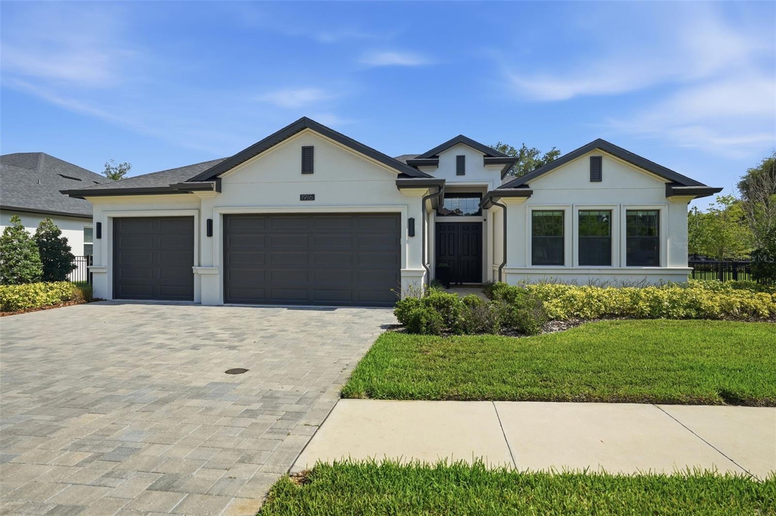 Fabulous executive home in gated Jullee Estates, quality built in 2023 by premier builder Gulfwind Homes and upgraded with magnificent detail throughout! This true open concept design seamlessly combines luxury, style, and functionality within an exclusive community of only 12 premium home sites. Offering over 3,000 square feet of immaculate one-story living space, this stunning home features 4 bedrooms, 4 full bathrooms, and an oversized 3-car garage. The striking curb appeal is enhanced by a paver driveway leading to an impressive double door entryway, soaring ceilings, and expansive open living spaces perfectly suited for everyday living and entertaining. The spacious floor plan includes a formal dining area within the sought-after great room layout and an inviting chef’s kitchen designed to impress. Gorgeous designer quartz countertops complement the custom cabinetry extending to the ceiling, while high-end Monogram appliances and an enormous center island provide the ideal space for casual dining, entertaining, and gathering with family and friends. The massive great room overlooks the covered lanai and outdoor kitchen, creating a seamless indoor-outdoor living experience perfect for enjoying the Florida lifestyle year-round. The luxurious primary suite features a spa-inspired ensuite bath with dual vanities, private water closet, enormous walk-in shower with designer tilework, and expansive his-and-hers walk-in closets. Secondary bedrooms are generously sized with ample closet space. All bathrooms showcase beautiful cabinetry, stylish hardware, and upscale finishes. The fenced backyard offers ultimate privacy, and even the laundry room has been thoughtfully designed with chic designer tile flooring. Jullee Estates is a natural gas community located in a non-evacuation zone with no flood insurance required. It is a golf cart friendly community convenient to the restaurants, entertainment, shopping and festivals of delightful Old Town Palm Harbor and Ozona as well as near to the famed Gulf beaches. Additionally, the area is zoned for some of Pinellas County’s most desirable schools including highly regarded Palm Harbor University High School. Bring your pickiest buyer as this exceptional home will not disappoint!