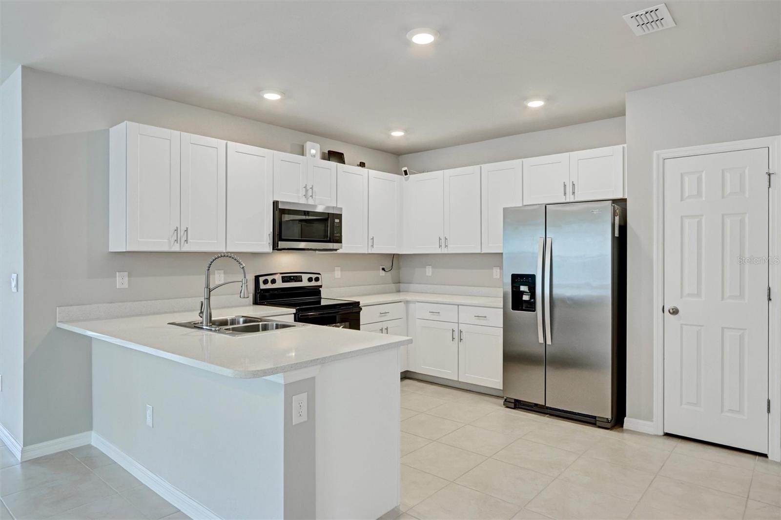 Beautiful 2-bedroom, 2-bath villa located in the desirable gated community of Magnolia Landing. Built in 2022, this well-maintained one-story home offers approximately 1,497 sq ft of living space with an open-concept layout designed for comfortable Florida living. The split-bedroom floor plan provides privacy, while the spacious living and dining area flows seamlessly into the kitchen—perfect for entertaining or everyday living. The home features a 2-car attached garage, modern finishes, and a lanai where you can relax and enjoy peaceful lake views. The primary suite offers a walk-in closet and en-suite bathroom, while the guest bedroom and bath are ideal for visitors or a home office. Residents of Magnolia Landing enjoy resort-style amenities including a championship golf course, community pool, fitness center, clubhouse, and dining options. Conveniently located near shopping, dining, and major roadways, this home offers the perfect blend of tranquility and accessibility in North Fort Myers.