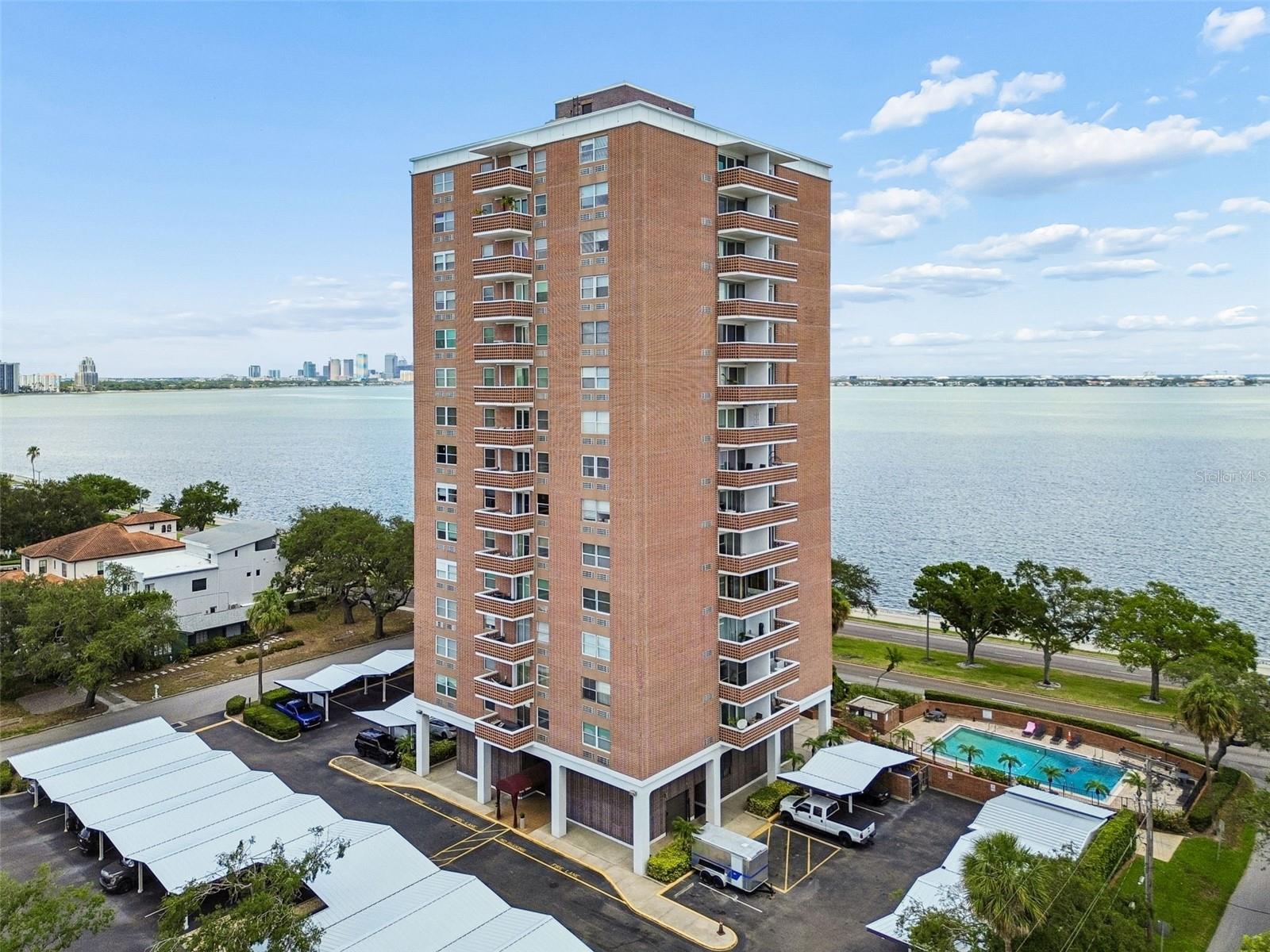 Enjoy waterfront living in this tastefully renovated condo situated along Tampa’s iconic Bayshore Boulevard. Located in the heart of South Tampa, this residence offers convenient access to top-rated schools (Roosevelt, Coleman, and Plant), popular local dining spots, boutique shopping, and the Bay—all just steps away. Designed for easy, move-in-ready living, the home features impact-rated windows and sliding glass doors, luxurious built-in custom closets and a thoughtfully updated kitchen with granite countertops, hardwood cabinetry, and a custom pantry for added storage. The modernized bathroom with walk-in shower completes the home's stylish interior. Step onto your private balcony and take in partial water and city views with spectacular evening sunsets. Bayshore Boulevard’s waterfront sidewalk is right outside, offering endless opportunities for walking, running, cycling, and enjoying Tampa’s beautiful waterfront scenery. Residents enjoy a variety of community amenities, including a waterfront swimming pool, assigned covered parking, a private storage unit, a bike storage room, ample guest parking and a recently updated lobby and hallways featuring fresh paint, new carpeting, and updated furnishings. A fully furnished guest suite with a kitchenette is also available for reservation, providing a comfortable option for visiting friends and family. They'll love having their own space! The building sits in Flood Zone X and has successful completion of the required Milestone Inspection and Reserve Study- no surprises here. This is a rare opportunity to own a beautifully updated condo on one of Tampa’s most sought-after waterfront corridors, offering outstanding value in a premier South Tampa location.