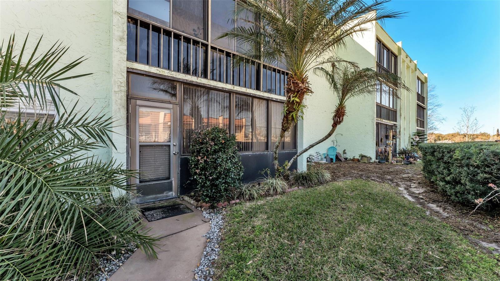 Welcome to this charming 2-bedroom, 2-bathroom ground floor condo of building A nestled in the heart of Central Lakeland. With your own touches and updates this would be the perfect place for you. Offering maintenance-free living and the pool conveniently located steps from your back enclosed lanai, this home perfectly blends comfort and convenience. The open floor plan flows seamlessly into the dining area, which overlooks a bright and airy Florida room, ideal for enjoying morning coffee or a quiet afternoon breeze. The kitchen has ample storage space with a pantry for additional storage while overlooking the dining room. Just off the kitchen is a dedicated laundry room complete with a washer and dryer for added ease. The primary bedroom offers sliding glass doors that open to the Florida room and an ensuite bathroom featuring a walk-in closet. The guest bedroom is located near the hallway bath, making it comfortable for guests or flexible living needs. The building provides convenient access to visiting neighboring units on the additional levels via both elevator and stairway. Residents enjoy community amenities including a pool, clubhouse, shuffleboard, and tennis court, as well as a designated covered parking space for this particular unit steps away from the front door with additional visitor parking available. Centrally located just minutes from downtown Lakeland, with easy access to both north and south Lakeland and convenient interstate travel to Tampa and Orlando, this condo offers an ideal location. Don’t miss the opportunity to make this delightful home yours. This unit is eligible for a quick closing at your timeline and showings are available daily. Schedule your showing today.