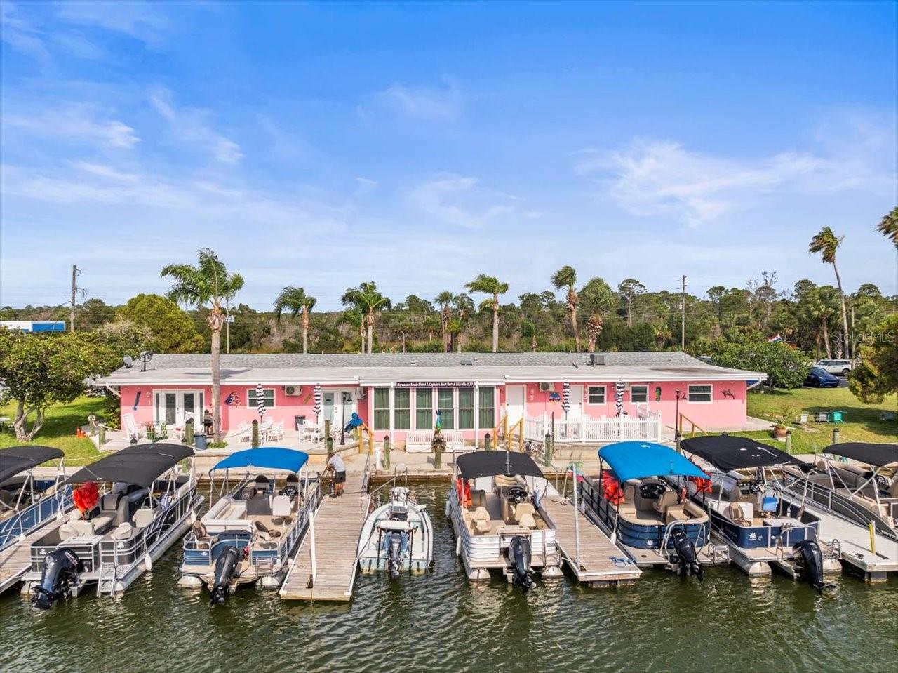 Investment Opportunity Awaits! Are you ready to own your own business and a piece of paradise on the beautiful Gulf Coast of America? Look no further than the Hernando Beach Boutique Motel and Resort located in The Village of Hernando Beach. This turnkey operation features 4 Luxury Efficiencies with full Kitchens overlooking the Canal that leads straight to the Gulf. Guest Suite #1 features 2 Bedrooms; one with 2 Full size beds and the other with 2 Queen size beds. Guest Suite # 2 King Side Bed. Guest Suite # 3 features 2 Bedrooms/ one with a King size bed with Twin beds and the other with a King size bed, a fantasy bath, formal dining and a daybed. Guest Suite #4 has one King size bed. The property has two Office spaces that are currently leased to local businesses and a brand-new self-service Commercial Laundromat that is open to the public. The Motel office is located in the center of the building and includes a beautiful Gift shop. Also included is our very successful Captains Boat Rental business with 10 top notch pontoon boats that are included in the sale price. The concrete sea wall is 305 feet long and has 12 floating docks accommodating 23 boats leading directly to the Gulf of America. The building sits on the right side of the one-acre lot leaving plenty of room for the expansion of an additional 18 room, three story motel. Preliminary plans have already been drawn up for the construction of a beautiful Key West style motel. The Village of Hernando Beach is surrounded by the Gulf of America on the West side and by eight parks within seven miles on the other side. The Weeki Wachee State Park with its world-famous live mermaid show is located only ten minutes away. The Village of Hernando Beach has just been designated as a coastal golf cart community which is an additional attraction. The Hernando Beach Boutique Motel with its own Captain's Boat Rental, laundromat and gift shop is a very profitable business with incredible potential for expansion. The building has been totally renovated in 2025 including all new electric, new plumbing, all new equipment and furniture. This is truly a turnkey operation. Work and play in paradise with this unique investment!