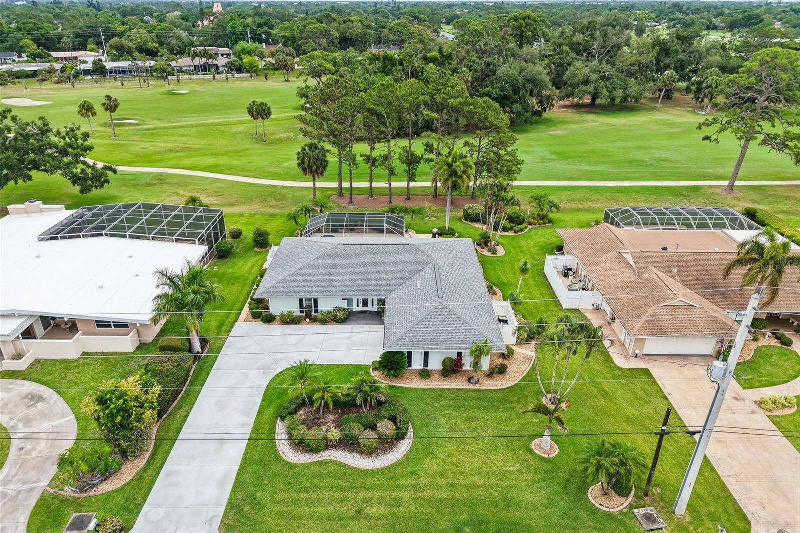 Experience the pinnacle of Florida’s mid-century charm in this impeccably maintained 3-bedroom, 2-bathroom residence with a side entry garage, perfectly situated on a premier golf course lot. Lowest price on the 7th tee!  This home has a private, resort-style oasis feel featuring a newly remodeled heated pool and spa, complete with modern Wi-Fi automation, outside security cameras & lighting, and a freshly re-screened cage—all framed by the lush, manicured fairways of the historic Sara Bay Country Club.  Inside, the home shines with 2022 upgrades, including Luxury Vinyl Plank flooring and a comprehensive Trane HVAC system with new ductwork. Whether you are enjoying a morning coffee with panoramic golf course views or hosting an alfresco dinner under the mature palms, this property offers a rare move-in-ready lifestyle. For the golf enthusiast, an optional private membership to Sara Bay Country Club may provide access to the legendary Donald Ross-designed course and exclusive social amenities, allowing you to tailor your country club experience to your own pace.  There is no mandatory HOA, but there are some special rules that apply to the neighborhood in the Manatee County Development Code that apply specifically to Whitfield. There is a voluntary Neighborhood Association for an annual fee of $30.  The Sara Bay Country Club currently grants neighborhood association members a free culinary membership to the club, which grants limited dining privileges at the clubhouse.  Schedule your showing today!