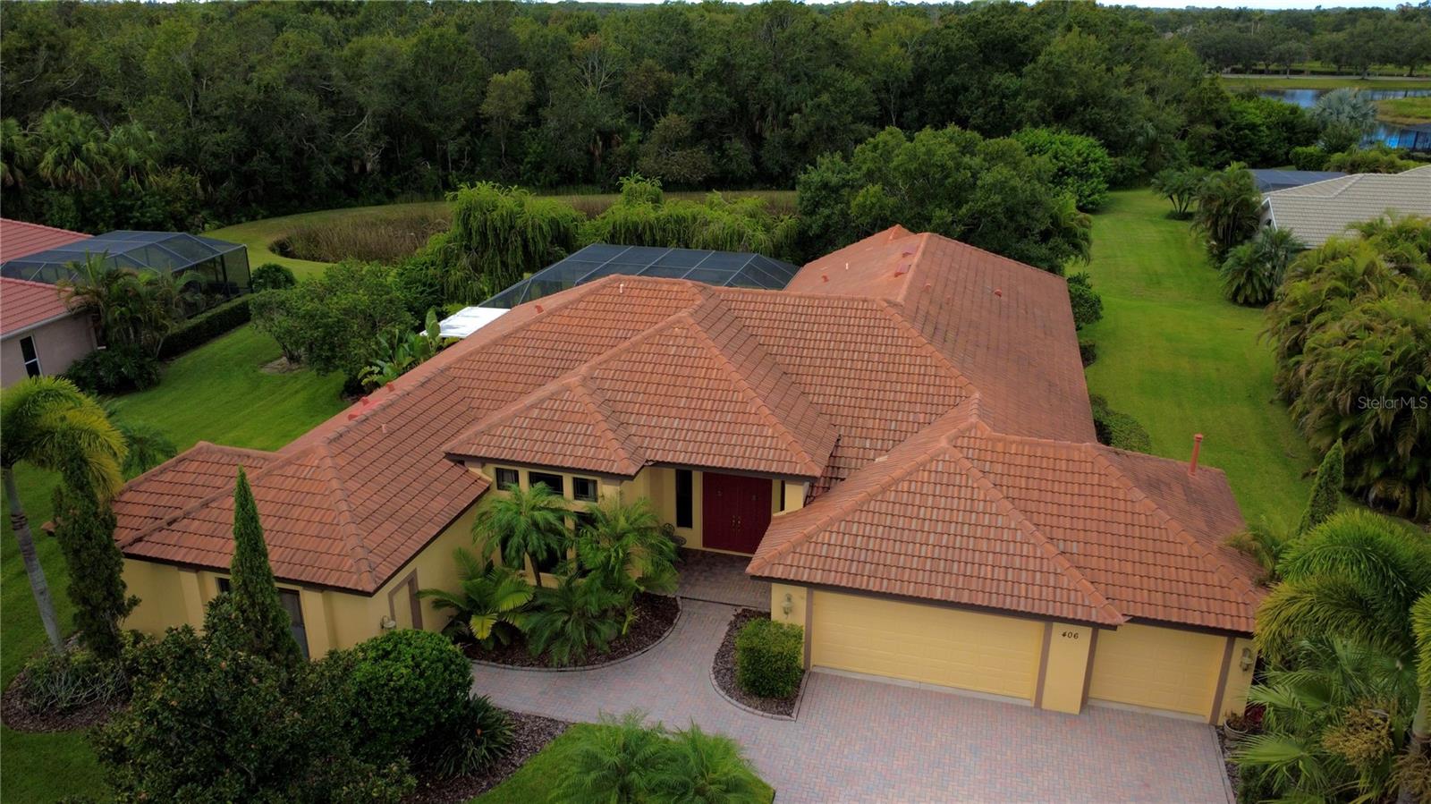 This Spanish/Mediterranean style home possesses some of the most enchanting backyard views available in Greyhawk Landing! The spaciously designed, 3,521 sqft, open floor plan, welcomes plenty of natural light to create a fluid, interconnected living and dining environment. Featuring granite countertops, wood cabinetry, and stainless-steel appliances; take pleasure in the gourmet kitchen, complete with a breakfast bar and kitchen dining area. Pocket sliding glass doors situated throughout the home offer a total of five access points straight to the backyard, allowing breathtaking views from every angle. The primary bedroom features two capacious walk-in closets, roman shower, jetted tub, and dual vanities. Three additional bedrooms with ample closet space provide both comfort and functionality; accompanied by two other bathrooms: one full, one half. The home generously includes two extra rooms: an office and bonus room. The outdoor space is a private sanctuary with its heated salt-water pool, integrated hot tub, rock waterfall, deck jets, and a summer kitchen - perfect for entertaining. A private pond reflects the surrounding beauty, creating a tranquil escape to unwind in the sights and sounds of nature. Enjoy peaceful moments by the pond or explore nearby nature trails within your gated community. Located within 0.5 miles of all your community upscale amenities including: pool, spa, clubhouse, fitness center, playground, pickleball courts, basketball courts, soccer fields and baseball fields. This home offers the best of both worlds - privacy and convenience. Plus, it's zoned for A-rated schools.Come check out your dream home!