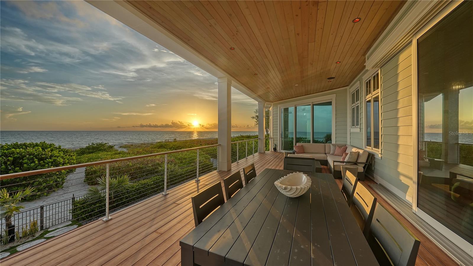 Unveiling the pinnacle of coastal living at this pristine beachfront residence at Bonaire Longboat Key. A newer gem completed in 2020, this luxurious home, offered turnkey furnished, is a rare find that invites you to immediately immerse yourself in the lap of waterfront luxury. The bliss of waking up to the Gulf's gentle waves is just the beginning of what this remarkable retreat has to offer. Crafted with precision and built by Eason Home Builders, this home seamlessly blends modern innovation with the allure of West Indies-inspired architecture. The result is a masterpiece that stands as a testament to lavish living on the Gulf of Mexico. Every corner of this residence is designed to capture the breathtaking beach views that stretch to the horizon. From the towering great room windows to the inviting balconies on each floor, the Gulf's beauty is your constant companion. Step into an interior that's not just beautiful but also brilliantly functional. Designer furnishings, smart home conveniences, and striking light fixtures harmonize with oak wood flooring and sleek surfaces, creating an ambiance that's as modern as it is inviting. The heart of this home is a chef's dream come true. The gourmet kitchen is a symphony of elegance and functionality, boasting custom cabinetry, a sprawling island, and top-of-the-line appliances. The CornuFe polished white and stainless-steel trimmed gas stove, accompanied by a statement-piece range hood, add to the allure of this culinary haven. The master suite is a sanctuary of indulgence. Set in a secluded northwest spot, it offers a private sitting area framed by bay windows, his and her walk-in closets, and a spa-inspired en-suite bathroom. This residence embraces the outdoors as an integral part of its charm. Balconies on each floor offer panoramic views and create a seamless indoor-outdoor flow. Recent updates enhance the allure of this home. A/V upgrades, solar shades, water softener, reverse osmosis, water chiller, and water pressure booster are just the beginning. The indoor cabana opens to a resort-style pool deck, complete with covered dining, a summer kitchen, lounge areas, a fire pit, and a saltwater pool with a swim bar and raised spa. Beyond the pool, your own gated access leads you to the pristine shores of the Gulf. The meticulously landscaped yard features a hammock, and convenient outdoor shower. This home also includes an additional parcel (the current owners have transformed this area into a botanical garden with beautiful lush landscaping).  All that's missing in this turnkey masterpiece is you. With your personal belongings, you can step right into the lap of luxury and start savoring every moment.