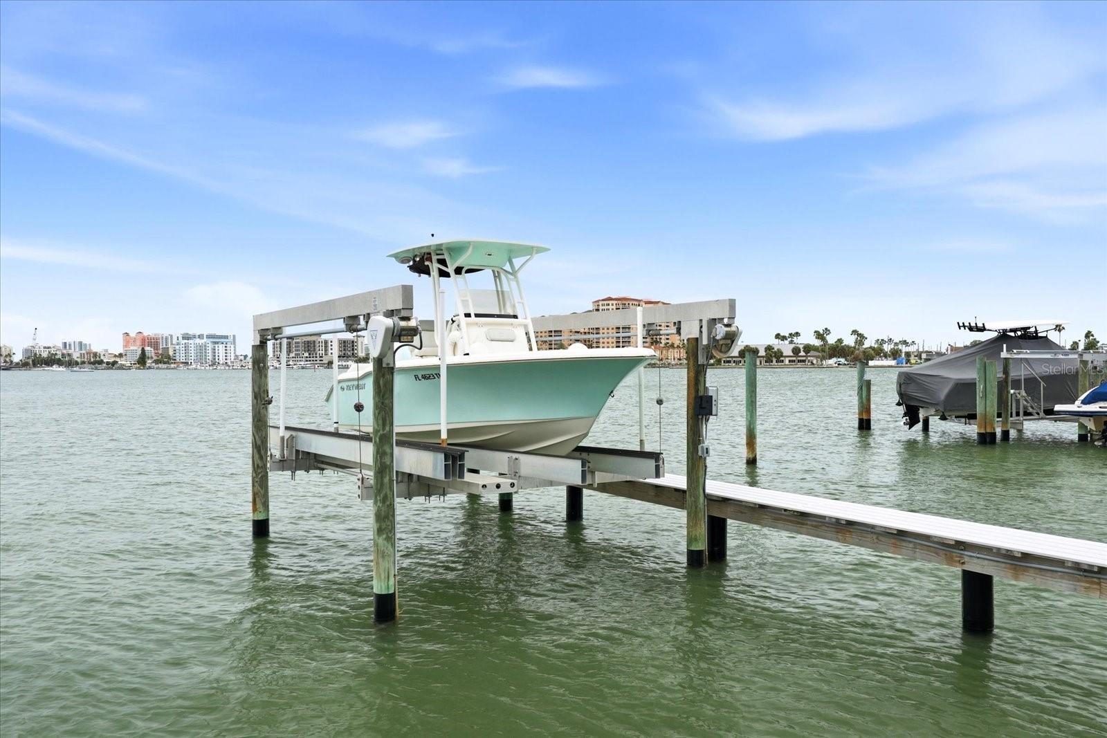 Your own BOAT SLIP with lift included as you live the island life on Island Estates in Clearwater Beach! Welcome to Unit 201 at 610 Island Way, a light-filled, end unit that has been gorgeously updated throughout. The kitchen features solid wood cabinets with marble countertops, sleek appliances and tile floors. An expanded pantry made for a chef is also equipped to store fishing rods + tools. Some windows have been upgraded to impact-rated including the 3 sliding glass doors. Remote, custom window treatments throughout are an added touch of convenience! Both bathrooms have been beautifully updated. The living room is spacious and leads to your private balcony overlooking the intracoastal where dolphins play and pelicans dive in. The primary suite also features its own private balcony and the primary walk-in closet has ample room for storage! Don't miss the sparkling year-round heated pool to soak up the sun. Covered parking space also included! HOA includes: exterior maintenance, ground maintenance, water, trash, cable, internet + building insurance! New seawall and dock in 2023 along with a new carport installed in 2025! Walk to Publix, bike Island Estates to Pier 60, or hop on the Jolley Trolley!
