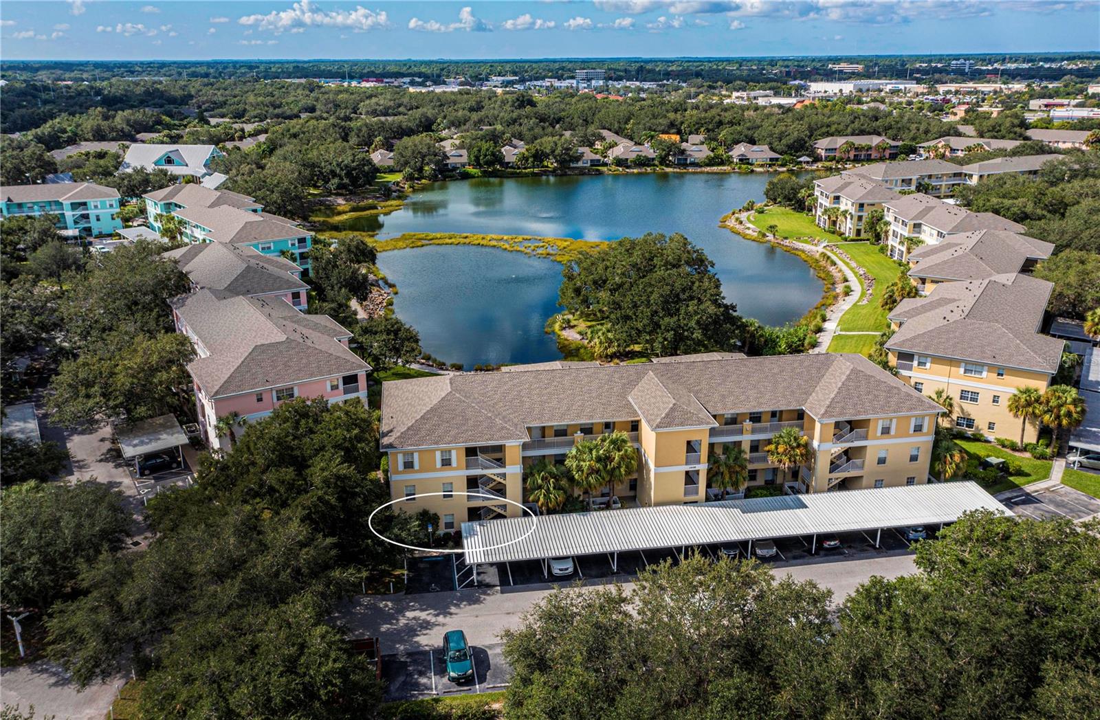 This rare lakefront 3-bedroom, 2-bath condo in the sought-after Heritage Oak Park is a true gem! Located on the first floor, it offers a stunning lake view and features only six units per floor, giving it larger room sizes than most. The open, light-filled floor plan includes a kitchen that flows into the great room and split bedrooms for added privacy. Highlights include raised panel cabinets in the kitchen and baths, Pergo Max laminate flooring throughout except for tile in wet areas and the lanai, an upgraded appliance package, laundry closet with stackable washer/dryer, window treatments, ceiling fans with lights, wallpaper accents, an upgraded kitchen sink and faucet, and a storm door for extra light. Recent updates include a new A/C and heat system in 2021, a water heater in 2025, and replaced carports and shingle roof in 2023. The condo is move-in ready and comes with a detached 1-car carport right out front. Gas grills are available for residents, and it’s just a short walk to the clubhouse and heated pool. Community perks include gated access, a fitness room, library, billiards, shuffleboard, horseshoes, tennis, bocce ball, pickleball, and a walking path around the large lake. With an on-site activities director, Heritage Oak Park offers a lively lifestyle surrounded by beautiful oak trees, all within walking distance of the YMCA, Publix, and the Charlotte County Library, and just a short drive to restaurants and shopping.