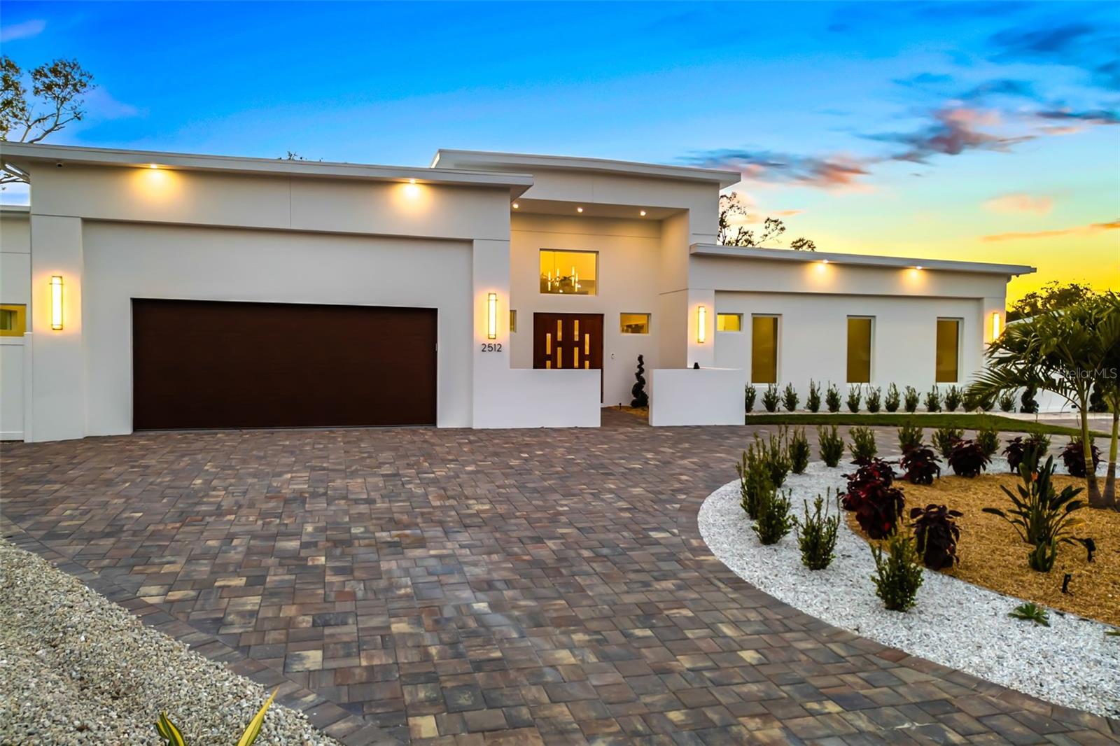 Complete with new photos as of 3/5/2025. Rare opportunity to own a brand new warm, relaxed modern one-level Sara Bay Construction ultra luxury residence on a third of an acre, East of the Trail, in South Gate. Enter the main home through the courtyard and step into a functional and timeless floor plan with soaring ceilings and white oak wire-brushed wood floors. The primary and three additional en suite bedrooms, and four full bathrooms plus a powder room flank the main living area and kitchen. The kitchen features top-of-the-line floor-to-ceiling solid light wood dovetail soft-close cabinetry, 3-cm quartz backsplash and countertops with waterfall edge, Monogram appliances including 6-burner gas stove/panel refrigerator/panel dishwasher, range hood, a walk-in pantry with limitless storage, oversized island, and more. The living space feature wall offers a built-in fireplace and the texture gives depth and sophistication under the glow of recessed, linear LED lighting. The large primary suite has tranquil views of the pool on one side and private garden patio on the other, as well as a bedroom-sized walk-in closet. The primary bathroom has dual vanities, top-of-the-line cabinetry, spacious frameless walk-in shower, stand-alone soak tub, built-ins, and water closet. The guesthouse (ADU) offers an additional two bedrooms and bathroom with living area, full kitchen and laundry. All with oversized 2-car garage and circular drive, fully equipped outdoor kitchen, outdoor shower and heated saltwater pool with spa and sun shelf to take in the southwest exposure, for perfect indirect, natural light and surreal sunsets. If you get in early, you still have time to choose your interior finishes with generous allowances and make your new Florida home dream a reality. Quality construction includes - Hydrologic enhanced plumbing fixture package, custom cabinetry throughout, single panel/solid core/8-foot interior doors, level-5 finish drywall, high impact hurricane glass, Icynene insulation, three AC zones, hot water recirculation system, smart home features, epoxy finished garage floor, oversized laundry room with the top LG washer/dryer combo and much more. Ask for full detailed feature/options list - subject to change, with the ability to select early on. Jefferson Circle is one of the few streets East of Trail that does not cut straight through and is a low-traffic street. Easy walk to Arlington Park pool, tennis and basketball courts, playground and rec facilities. Highly sought-after area, Southside Elementary, minutes to Southside Village, SMH, Selby Gardens, the bayfront, downtown, Siesta and Lido beaches, St. Armands Circle and more.