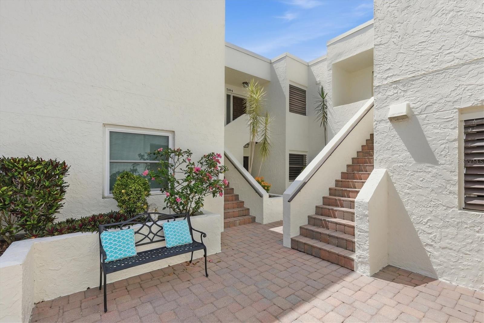 Discover relaxed resort-style living in this updated end-unit condominium residence in The Meadows, where tranquil lake and golf course views create a picturesque backdrop for everyday living. Offering approximately 1,500 square feet, this two-bedroom, two-bath home combines comfort, convenience and an inviting indoor-outdoor lifestyle in one of Sarasota’s established communities. Filled with natural light, the residence features new carpet throughout the living room, dining area and bedrooms, enhancing the bright and welcoming interior. The kitchen was thoughtfully updated in 2018 with granite countertops and stainless steel appliances, while a spacious pantry provides convenient access to the stack washer and dryer and water heater. Hurricane-impact windows have been installed throughout, and the HVAC system has been updated within the past several years for added peace of mind. Community roofs were replaced in 2022. Residents of Heronmere II enjoy access to a private community pool included in the condominium fee, along with optional membership opportunities at The Meadows Country Club. Amenities include golf, a newly enhanced fitness and wellness center, personal training, a Junior Olympic lap pool, tennis and pickleball with flexible membership options and à la carte pricing. Just moments from The Meadows Village Center with shopping and dining, this residence is surrounded by mature oak canopies, lush greenery and miles of scenic recreational and biking trails. Ideally near University Town Center, Nathan Benderson Park and downtown Sarasota, residents enjoy convenient access to shopping, dining, cultural attractions and year-round outdoor recreation. Move-in ready and designed for effortless Florida living, this residence offers an exceptional opportunity to enjoy the sought-after Meadows lifestyle.