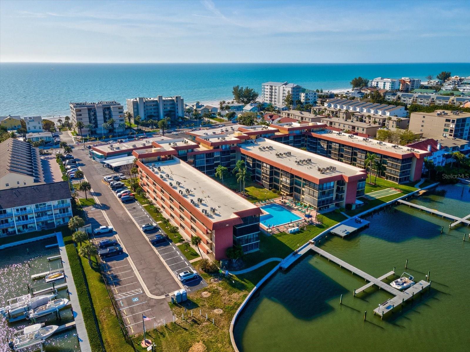 Experience the best of Florida coastal living in this fully renovated 2-bedroom, 2-bath condo at The Bay Mariner Condominiums in Indian Shores. This move-in-ready residence offers an opportunity to own a refreshed coastal property in one of the most desirable locations along Florida’s Gulf Beaches. Situated within a waterfront Intracoastal community spanning nearly four acres of tropical landscaping and more than 400 feet of shoreline, the property offers the perfect balance of waterfront living, beach access, and resort-style amenities. The bright interior features updated finishes, a comfortable layout, a primary suite with en-suite bath and walk-in closet, and a versatile second bedroom ideal for guests, a home office, or additional living space.

Residents enjoy a relaxed waterfront atmosphere where boats pass along the Intracoastal and Florida wildlife can often be seen just outside. Community amenities include a heated waterfront pool and spa, fishing pier, boat docks for boating and kayaking, clubhouse, shuffleboard courts, bike storage, covered carport parking, and beautifully maintained tropical grounds. Indian Shores Beach is directly across the street, providing quick access to the soft white sands and Gulf waters for beach days and sunset walks. Restaurants, cafés, beach bars, and convenience shops are within walking distance, making everyday living easy and enjoyable. This pet-friendly community allows immediate rentals, creating an excellent opportunity for a primary residence, vacation home, or income-producing investment property. Conveniently located near shopping, dining, and two major airports—St. Pete–Clearwater International Airport and Tampa International Airport.