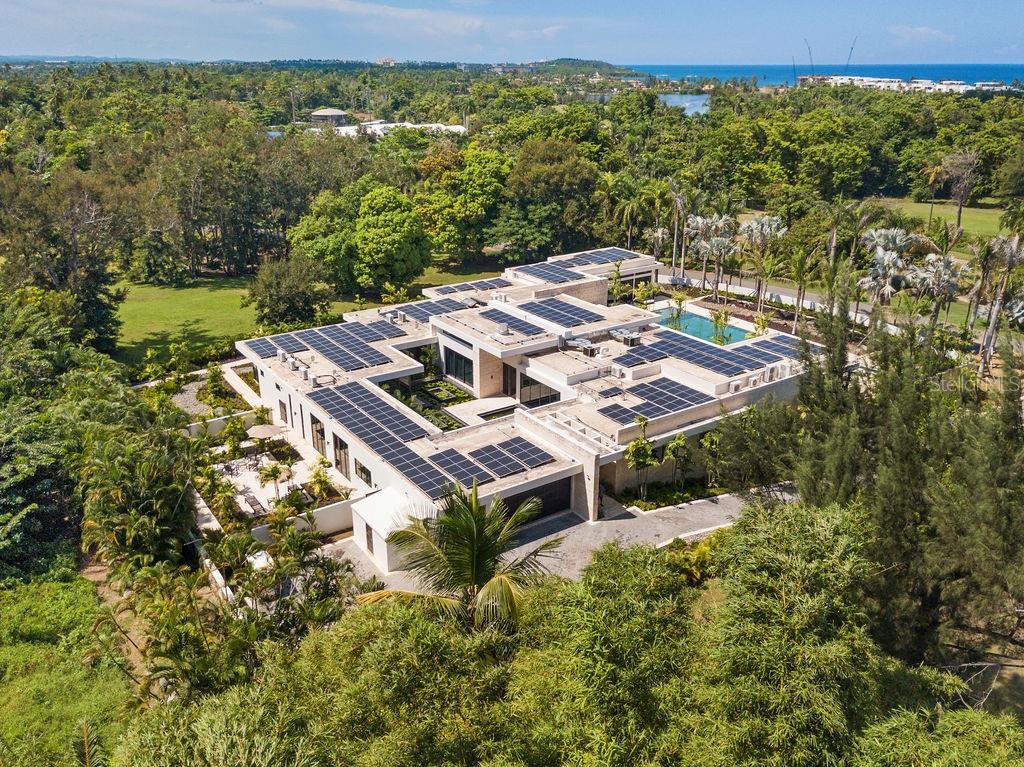 Dorado Beach Estates 17

This distinctive estate in Dorado Beach Estates is a true one-of-a-kind residence in a class of its own. Unparalleled luxury, modern elegance, and grand spaces perfectly describe Estates 17.

This newly constructed home with a total area of approximately 20,629 sq feet, is located in the exclusive gated community of Dorado Beach Estates, one of the most exclusive, private and desired neighbors within Dorado Beach a Ritz-Carlton Reserve.

From the moment you pass through the front entrance, you know that you have arrived someplace very special. A stunning 30,000 gallon Koi Pond welcomes you and brings the outdoors in, providing soul soothing views from almost every room in the home. 

The main home offers 4 bedrooms with ensuite bathrooms, including an office/flex bedroom space. Additionally, it features an attached fully equipped Casita with separate entrance and a 6,511 sq foot basement with additional parking space and three multi-use air conditioned rooms.

All the interiors enjoy exceptional height and warmth thanks to the beautiful travertine floors and the floor to ceiling Coralina Wall throughout. Together with 10’ sliding doors they create a sense of space and make the most of the abundant light and the views. Textures and materials such as Taj Mahal granite, Exotic Sahara Noir and Velluto Onyx countertops show that no expense was spared. 

The modern, fully fitted, open plan main kitchen with views of the pool features Sub Zero Refrigerator and Freezer, Wolf appliances (microwave, steam oven, 60’’ range with (2) ovens, a commanding 11’x6’ imported marble island and Poliform built-in cabinets throughout. For those who appreciate entertaining the home features an additional Prep Kitchen filled with (2) Refrigerators, (2) Freezers, (2) Wine/Champagne Refrigerators (all Sub Zero), electric cook top, a polished Taj Mahal granite counter top 11x 4.5 ft island and plenty of additional storage. 

The elegant dining room is positioned overlooking the Koi Pond and features a reflective floor to ceiling mirror tile, which showcases the reflection of the Koi Pond and it’s fragrant flowering water lilies. 

With views over the pool and golf course, a master retreat for relaxation and entertainment, an expansive bathroom area and featuring a commercial Gym. The master bath has a stunning 2 person infinity spa tub with Calacatta Gold marble and separate His and Hers commode closets, showers, and walk in closets, for those who appreciate their own spaces and privacy. The sale of the home includes all the Gym’s state of the art equipment. 

Through the elegant sliding pocket doors, you’ll find a spacious outdoor terrace that features a 85’ x 30’ salt water swimming pool, with imported Indonesian Sukabumi cut stone tile. 

Finally, eco-friendly and sustainable amenities include a (238) Hanwa solar panels, 9 Tesla batteries, commercial Volvo generator, commercial grade water filtration & reverse osmosis system and (2) 2,500 gallon water cisterns. Additionally, the villa incorporates all the state-of-the-art home automation features such as Insteon lighting, Bose multi-room audio and separately controlled HVAC systems in each room, security system with cameras and pool lighting controlled from smart home applications on the owner’s phone and tablet.