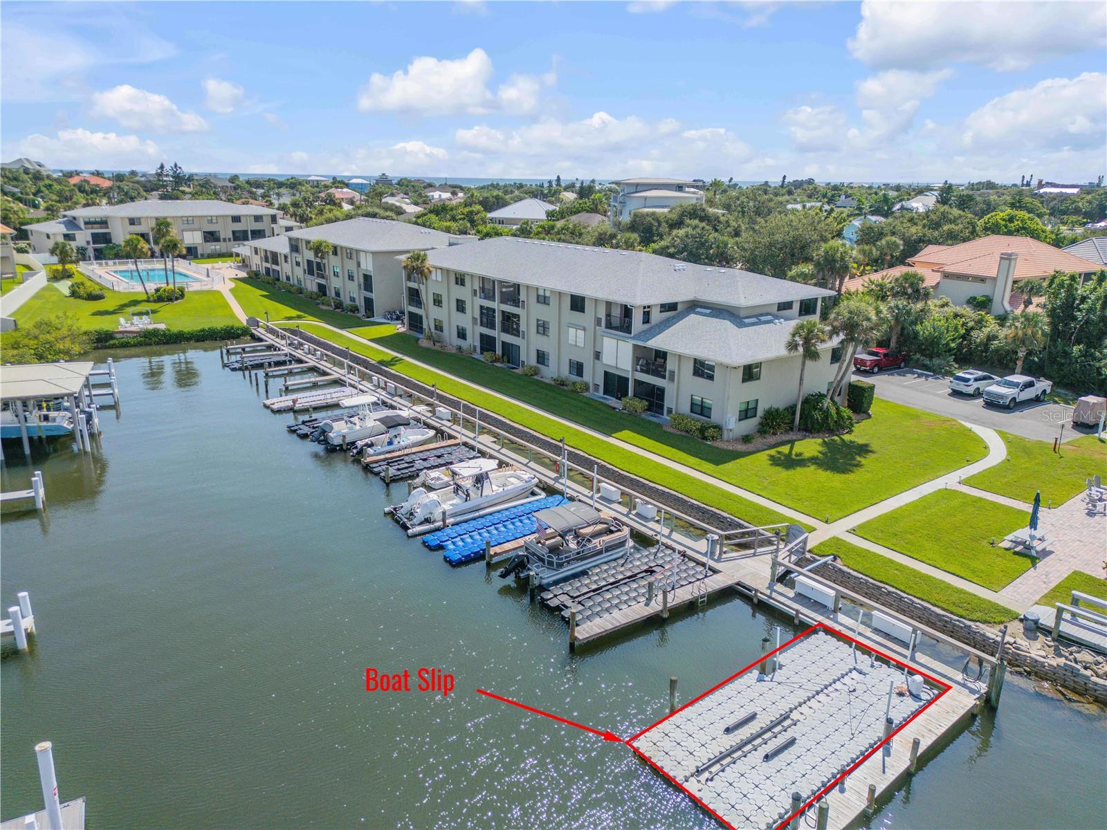 Boater's dream in North Beach! This condo comes with a deeded 15x30 deep-water boat slip (2nd in off the Intracoastal) featuring a floating dock that easily fits up to a 32' center console — depth has never been an issue at this coveted slip location. Set in the gated, dog-friendly Ocean Inlet and Yacht Club, this beautifully updated 2BR/2BA, 3rd-floor open-concept condo offers stunning river views from multiple rooms and the private balcony, complete with Roladen shutters for privacy and storm protection. The updated kitchen boasts ample cabinetry and storage, plus a pull-down attic for even more space. Enjoy resort-style amenities including a riverfront pool, kiddie pool, clubhouse with kitchen/BBQ area, riverfront seating, and a fishing pier with cleaning station. Just a short walk to the beach walk-over and Smyrna Dunes Park. A true turnkey Intracoastal boating lifestyle in the heart of New Smyrna Beach!