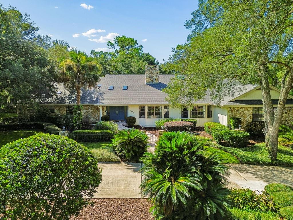 Welcome home to Sweetwater Country Club, one of Central Florida's most sought-after communities, where tree-lined streets, oversized homesites, and a peaceful atmosphere create the perfect place to put down roots. Situated on an incredible 1.5-acre homesite in a top-rated school district, this home offers the space and flexibility to grow, entertain, and make lasting memories for years to come. Designed with everyday living in mind, this home offers the perfect balance of togetherness and privacy. Picture holiday dinners in the formal dining room, cozy evenings by the fireplace, and movie nights in the expansive family room, where soaring ceilings and walls of windows create a bright, inviting space everyone naturally gathers in. The open flow between the family room and kitchen makes it easy to stay connected whether you're preparing dinner, helping with homework, or hosting friends for game day. The split floor plan allows everyone to have their own space, while the upstairs loft is the perfect bonus area for a game room, kids' hangout, home theater, or study space. At the end of the day, retreat to your oversized primary suite, complete with two walk-in closets, a fireplace, dual vanities, a soaking tub, walk-in shower, and private access to a tranquil courtyard—perfect for enjoying your morning coffee or unwinding with a good book. Just off the suite, the private den offers endless possibilities as a home office, nursery, fitness room, or quiet escape. On the opposite side of the home, family and guests will appreciate spacious bedrooms, including two with private en-suite bathrooms for added comfort and convenience. The true showstopper is the outdoor living space. Open the doors to the sunroom and take in views of the sparkling pool and sprawling backyard, where there's room for everything from birthday parties and family football games to quiet evenings under the stars. With 1.5 acres of privacy surrounded by mature landscaping, you'll enjoy the feeling of having your own private retreat while still being close to everything. Life in Sweetwater Club is about so much more than just the home—it's about the lifestyle that comes with it. Spend weekends relaxing at Sweetwater Beach with deeded access to beautiful Lake Brantley, launch your kayak or paddleboard for a day on the water, cool off at the community pool, let the kids enjoy the parks and playgrounds, take your pup to the dog park, or hit the links at the nearby golf course. Every day offers a new way to enjoy the Florida lifestyle. Beyond the manned guard gates, you'll find even more to explore. You're just minutes from Wekiwa Springs State Park, Wekiva Island, scenic walking and biking trails, popular shopping and dining destinations, and have convenient access to I-4 for an easy commute to Downtown Orlando, world-famous attractions, and Florida's beautiful east coast beaches. This is more than a home—it's the lifestyle you've been waiting for. Schedule your private showing today!