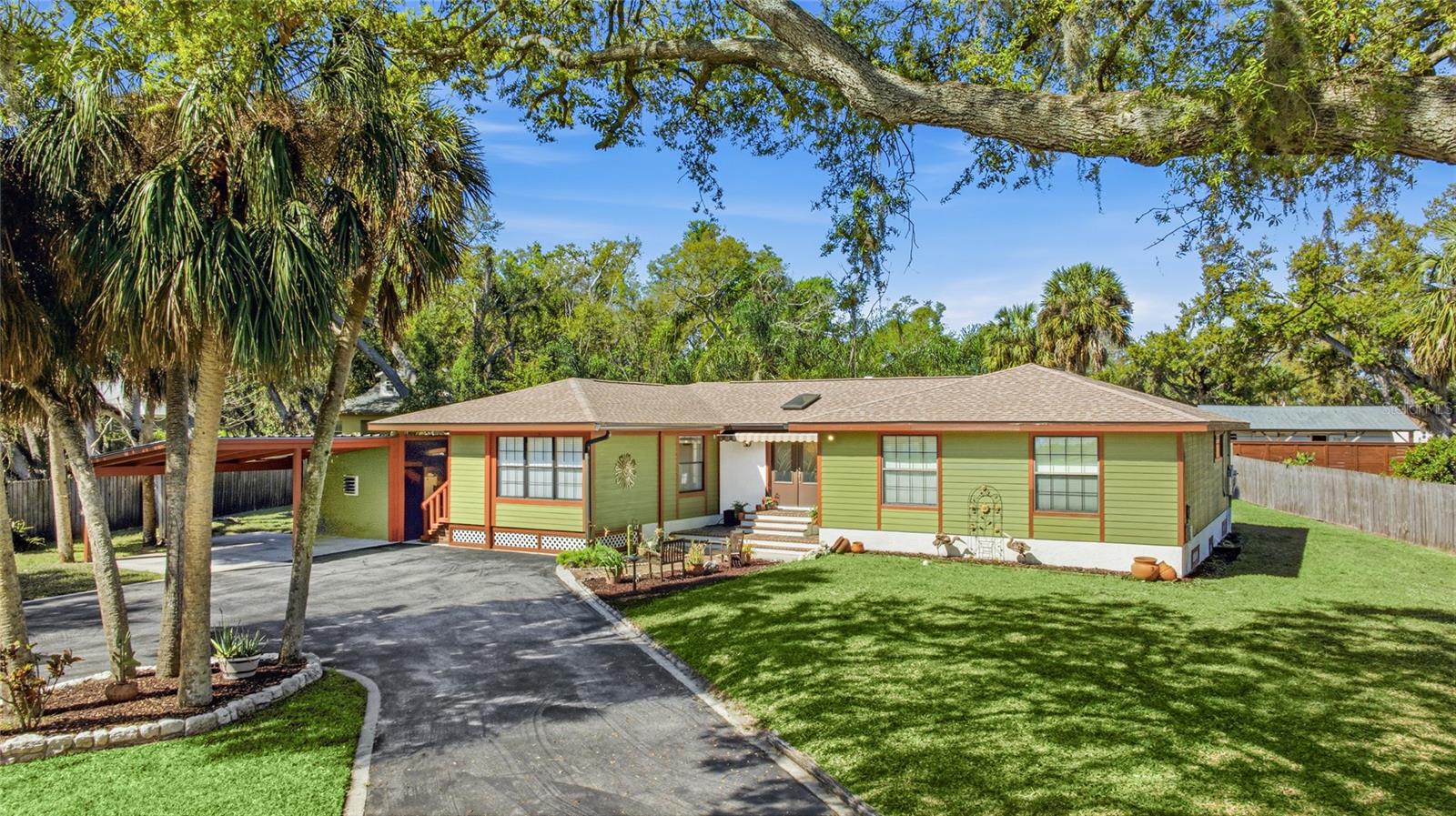 Located in a beautiful setting across the street from the Braden River, this inviting 4 bedroom 2.5 home bath home greets you with views of a sprawling gorgeous oak tree as you arrive.  The tranquil atmosphere, cool river breezes and scent of salt air hint at the lifestyle you'll be enjoying.  A historic brick paver entry dating from the late 1800's to early 1900's creates timeless character as you enter through the beautiful glass leaded double doors into a home filled with warmth and personality.  The kitchen, which views the patio and backyard, features stainless steel appliances, pull out shelving drawers and a barstool counter. This comfortable home offers two living areas with the front family room currently set up as an inspiring artist's studio overlooking the river across the street and it's amazing sunrises in addition to a second living area that is open to the kitchen. The primary bedroom is exceptionally well sized with abundant space to accommodate your furniture needs. Three additional bedrooms and 2.5 baths, provide plenty of options for family and guests. The wood beamed outdoor covered patio area showcases a swinging picnic table and a custom carved art piece built in just for this area. Hobbyists will love the large outdoor screened in workshop wired for electricity that is ready for your creations located adjacent to a 2nd patio bonus area.  Step outdoors to a private retreat and a fully fenced backyard situated on .44 acre with more than enough room to add a swimming pool.  This special property even features a rare artesian well along with being elevated on 4 courses of block that provides lower insurance costs for you. Additional features include skylights, brand new front gutters, 2024 roof, hurricane rated entry doors, an $21,000 Enphase Solar System, fully paid for, installed in 2021 (not visible from the front elevation) representing HUGE SAVINGS on your utility bills averaging $30 mo. and a 2018 A/C and water heater. Assume an unbelievably affordable $1109 annual Flood Insurable Policy! Non-deed restricted with no HOA or CDD fees. The boating enthusiast will love the quick 2 minute access to reach the SR 64 boat ramp. Detweiler fans will be happy to know a new close-by location is coming. This is a very special one of a kind home with river views and refreshing breezes in a setting that blends in perfectly with nature.