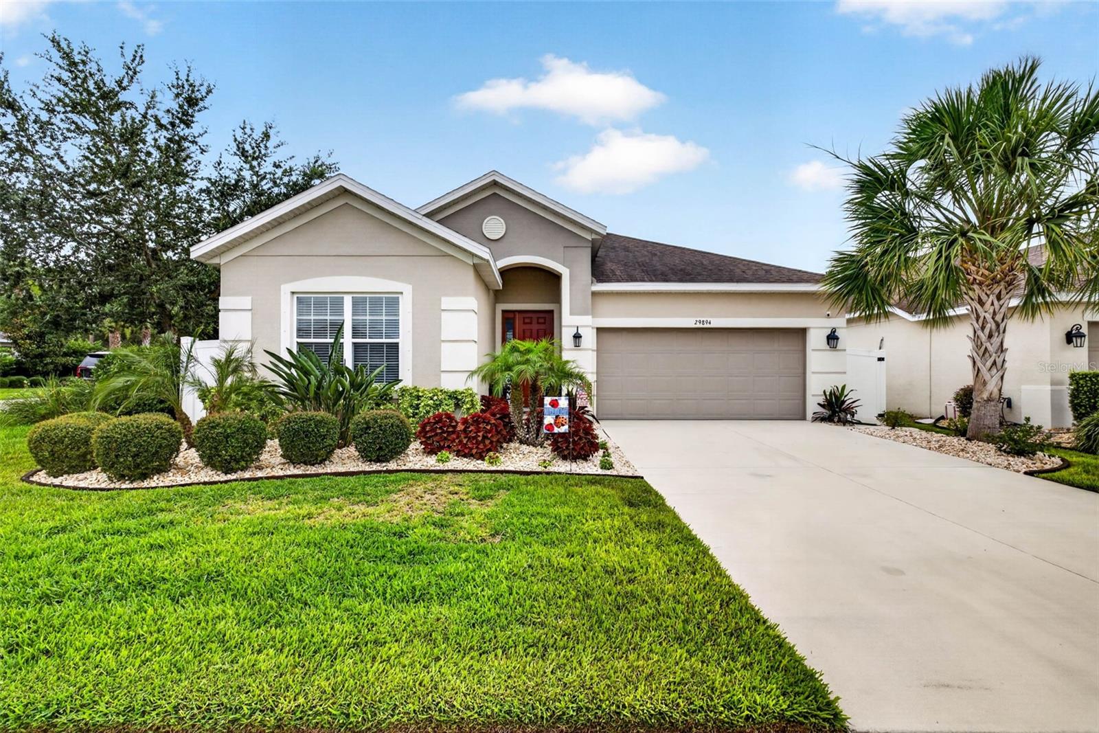 Built in 2020, this beautifully maintained single story pool home in Wesley Chapel offers a low HOA, no CDD, and the Florida lifestyle buyers are looking for. From the inviting front entry and attractive curb appeal to the bright, thoughtfully designed interior, this home creates a warm first impression the moment you arrive. Inside, you are welcomed by a spacious foyer featuring a tray ceiling, elegant statement lighting, neutral tones, and beautiful wood look tile flooring that flows throughout the main living areas. A large flex room provides endless possibilities and is currently used as a craft room, but could also serve as a home office, playroom, media room, fitness space, or additional living area. The kitchen is beautifully appointed with white cabinetry, stylish hardware, subway tile backsplash, recessed lighting, and generous counter space. A convenient built in serving area or coffee bar adds both charm and functionality. The kitchen also features quartz style countertops, stainless steel appliances, modern pendant lighting, a large center island with additional storage and prep space, and an oversized walk in pantry. The kitchen flows seamlessly into the dining and living areas, making it perfect for everyday living and entertaining. The dining area offers plenty of room for hosting meals, celebrations, and everyday family time. The adjoining family room is spacious and inviting with recessed lighting, a ceiling fan, neutral finishes, and sliding glass doors that lead directly to the screened pool area. This easy indoor and outdoor connection makes the home ideal for entertaining and relaxed everyday living. The primary suite is spacious and comfortable, featuring a tray ceiling, recessed lighting, a ceiling fan, soft carpet, and a large window overlooking the screened pool area. The en suite bathroom offers dual sinks, a large vanity, soaking tub, separate walk in shower, private water closet, and neutral tile finishes. The large customized walk in closet includes built in shelving, drawers, hanging space, and shoe storage. The secondary bedrooms are also comfortable and versatile, offering space for family, guests, hobbies, or work from home needs. One bedroom is currently set up as a home office, while another features a charming accent wall and decorative ceiling detail. Additional bathrooms include a tub and shower combination and a tiled walk in shower with glass enclosure. Step outside to your own private screened outdoor retreat featuring a beautiful pool with water features, a spacious travertine style pool deck, and a covered lanai perfect for outdoor dining, grilling, and relaxing in the shade. The fenced backyard, mature greenery, and screened enclosure create a comfortable setting for enjoying Florida living year round. With stylish updates, flexible living space, a beautiful kitchen, generous storage, comfortable bedrooms, and a private screened pool, this Wesley Chapel home offers the comfort, function, and lifestyle today’s buyers are looking for. Schedule your private showing today.