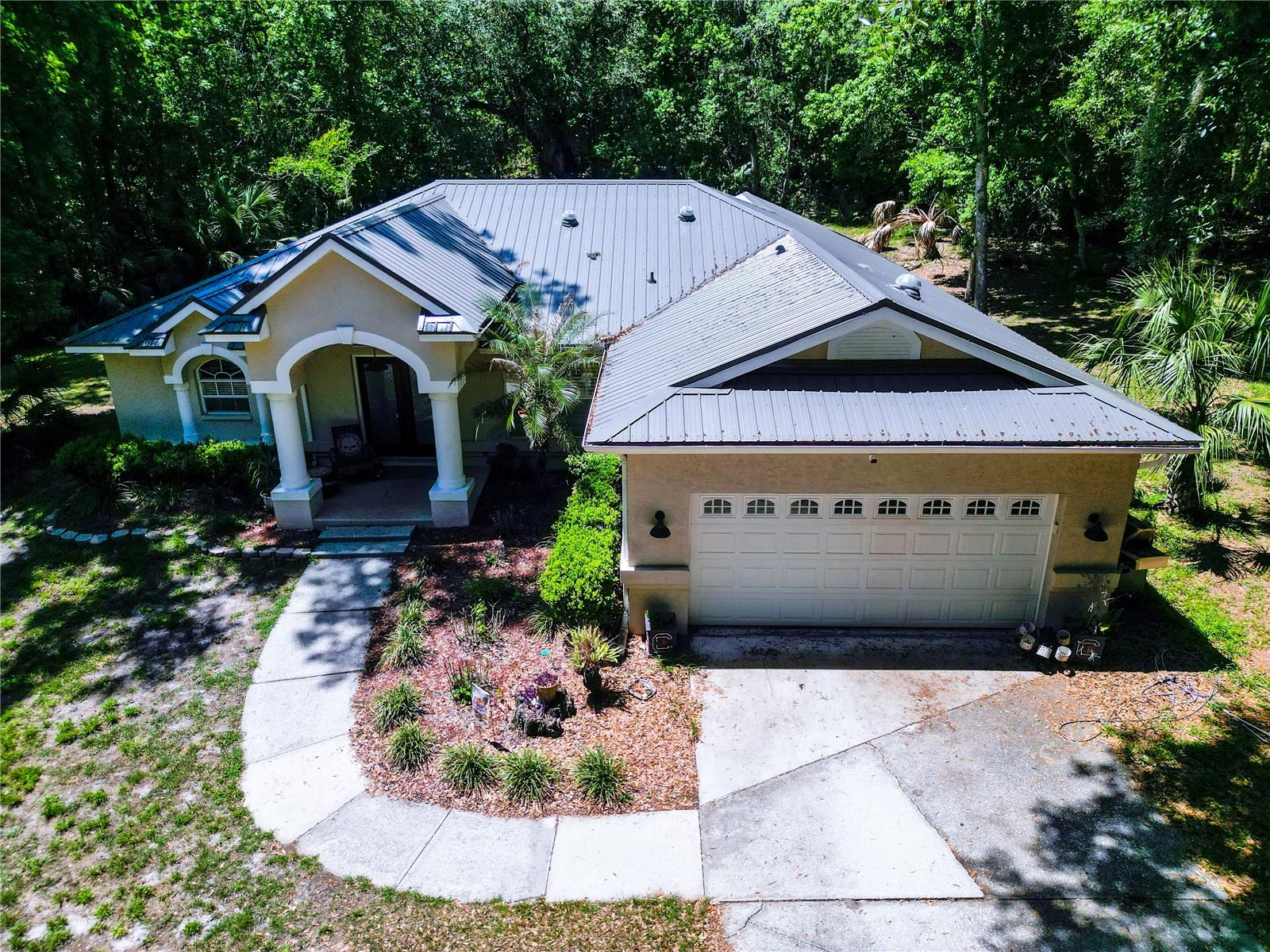 Experience the perfect balance of privacy, space, and modern updates with this exceptional 4-bedroom, 2-bath pool home situated on 5 acres in Brooksville. Surrounded by mature oak trees and natural Florida landscape, this property offers a peaceful setting while still providing convenient access to nearby amenities. Inside, the home features ceramic tile in the main living areas and the primary suite, an updated primary bathroom, and a well-appointed kitchen with granite countertops and newer stainless steel appliances. Major improvements include a metal roof installed just one year ago, a newly paved driveway, and a newer HVAC system (2023), offering both value and peace of mind.Step outside to enjoy your private pool and expansive acreage, ideal for entertaining, outdoor activities, or simply enjoying the natural surroundings. The property also includes a 2-car attached garage and an additional detached 2-car garage/workshop, providing ample storage and workspace options. Zoned AR, this property allows for flexibility in use and lifestyle.A recent appraisal completed this month reflects the home’s value, and it is currently listed under appraised value, presenting a compelling opportunity for buyers. The sellers are motivated and prepared to move quickly. Seller is offering up to $5,000 toward the buyer’s prepaids and closing costs with an acceptable offer. Schedule your private showing today to fully appreciate everything this property has to offer.