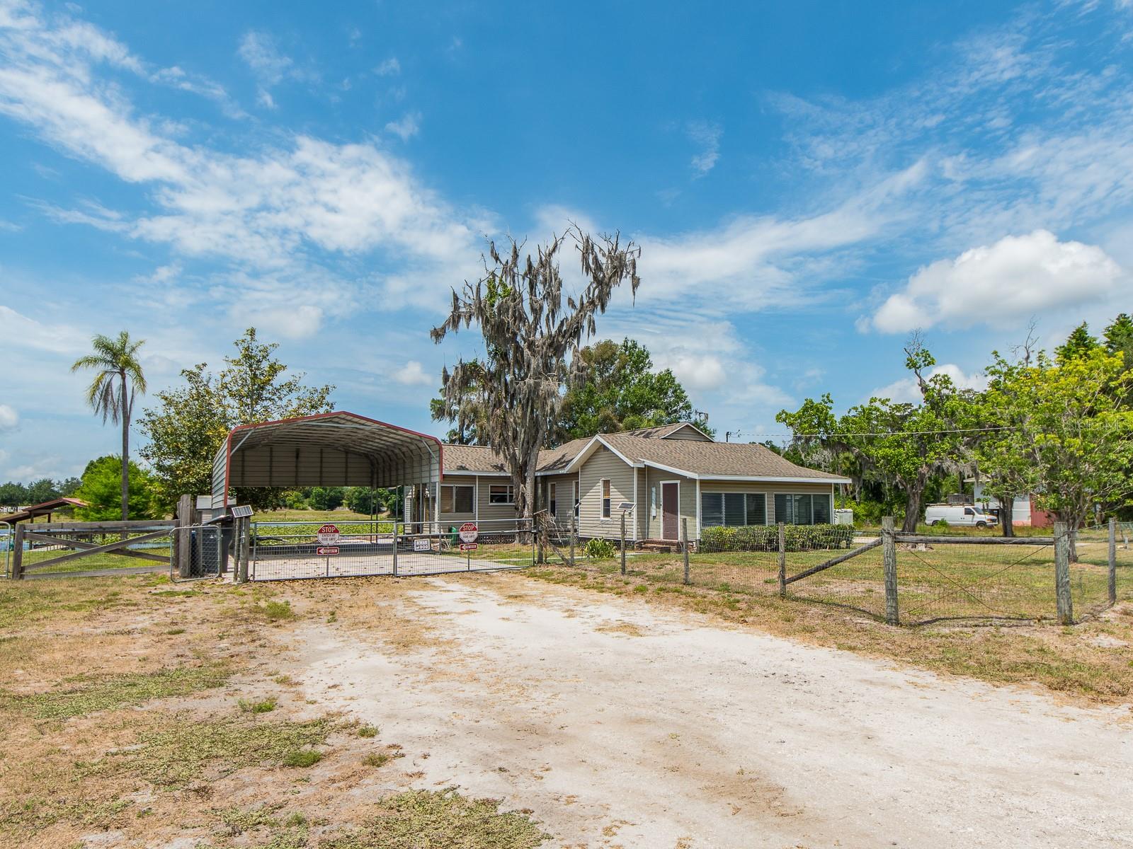 NEW PRICE  - Seller Motivated for real offers !!  Rare opportunity to own lakefront property in a quiet, tucked-away area of the Keystone / Odessa area with no HOA or deed restrictions. Situated on a 0.38 -acre lot, this 2-bedroom, 1-bath home offers the perfect combination of waterfront views, privacy, and flexibility. Inside, the home features a light-filled Florida room, a comfortable living area with a wood-burning fireplace, a spacious dining area, and an eat-in kitchen with a functional layout. The bedrooms provide flexibility for a variety of uses, while the overall layout provides a comfortable and practical living space. The interior retains its original character, key system updates provide added peace of mind, including a new roof (2021), new A/C compressor (2025), new well pump (2024), reverse osmosis system, and a recently purchased water refinement system ($13,000). Outdoors is where this property truly stands out, highlighted by a free-form, glass-tiled pool overlooking the lake, complete with a heater for year-round enjoyment. The property also features a large covered carport with ample space for RV or boat parking, offering versatility for a variety of lifestyles. Enjoy true Florida lakefront living, fish, kayak, or simply unwind from your own backyard, while still being conveniently located near shopping, dining, medical facilities, Tampa International Airport, parks, and Gulf beaches. Whether you're looking to renovate, invest, or create your own private waterfront retreat, this is a unique opportunity in Keystone / Odessa Market.
