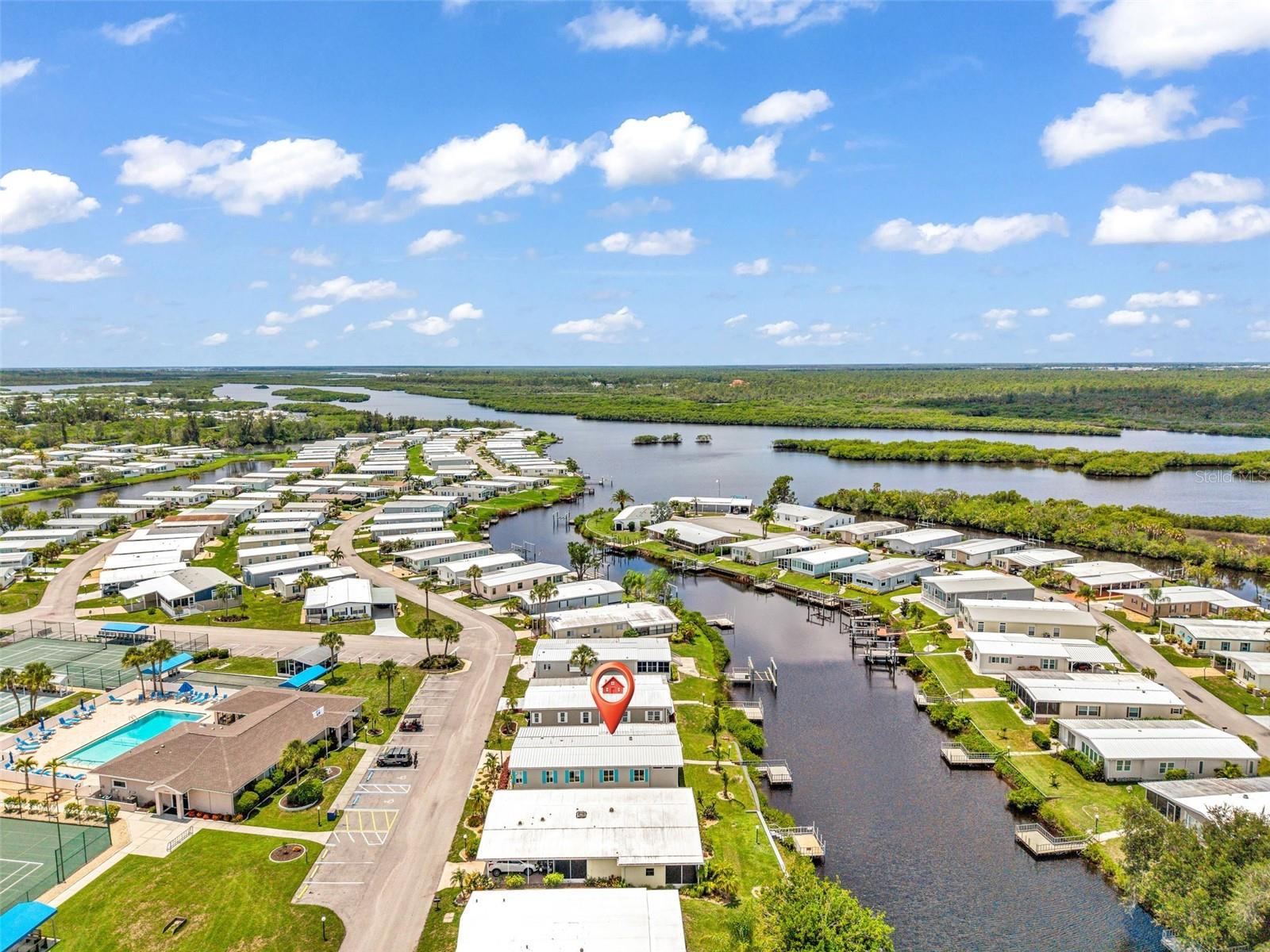 Welcome to Lazy River Village! One of the premiere 55+ waterfront manufactured parks in all of Sarasota and Charlotte Counties! The BEST amenities, clubs, and selection of activities you will find in any co-op park. Lazy River is located on the banks of the beautiful Myakka River. Florida wildlife surrounds you! 

This STUNNING WATERFRONT home with BOATING access will have you dreaming of "Florida living" at its best. Excellently maintained and renovated, this home welcomes you into a bright living space where form and function combine seamlessly. Wood Bamboo flooring in main areas of home and upgraded flooring in bedrooms!!! The kitchen boasts STAINLESS STEEL appliances, a GORGEOUS tiled backsplash, and an eleven foot long QUARTZ kitchen counter-island with seating for casual meals & a dining nook that looks out over the canal. SOFT-CLOSE cabinets.  The primary bedroom has an ensuite bathroom and large walk-in closet. DUAL SINKS in BOTH bathrooms. The secondary bedroom has two built-in closets. The OPEN FLOOR PLAN has a spacious living room and adjacent dining room. Window upgrades include an EXTRA LARGE window that looks out over the water. A large enclosed Florida room offers VERSATILE space for relaxing, entertaining, or hobbies. This WATERFRONT home has a concrete dock with WATER and ELECTRICITY that overlooks the canal which empties into the Myakka River. NEW 2024 METAL ROOF! Shed is INSULATED with a separate AIR CONDITIONER. Some furnishings convey!

This home is the perfect seasonal place to enjoy Florida's coveted gorgeous winters and a perfect year-round home for those who love all 4 seasons of Florida. If you enjoy an abundance of activities, you will have plenty to choose from in Lazy River Village: Pickleball, tennis, bike clubs, card clubs, and pontoon boating. They even have a professional woodworking shop. A low monthly fee of $288 includes all the amenities. There are other amenities for an extra fee, such as a marina slip if your home is not located on the water. One of the things that makes Lazy River Village so great is its proximity to...well...everything! Be prepared to enjoy Florida's wildlife at its finest, both inside the Lazy River Village complex and at abundant state parks and nature preserves. Shopping and dining surround you in all directions. The spring training homes of both the Atlanta Braves & the Tampa Bay Rays are just a minutes away. The world-renowned Gulf of Mexico beaches are all within 30 minutes or less! 1) Englewood beach, 2) Casperson Beach (GREAT for shelling), 3) Venice Beach (shark tooth capital of the world), 4) Brohard Paw Park, 5) Nokomis beach (you've GOT to experience the weekly drum circles), 6) the island gem of southwest Florida: Boca Grande... And finally: 7) Siesta Key in Sarasota has been ranked multiple times as the number one beach in the nation and is a mere 35 minutes away. Lazy River Village offers a lifestyle that every retiree dreams of. You have the quaint downtowns of Venice and Punta Gorda--both cities are often ranked as Top 10 destinations in the country for retirement. Another local favorite, Englewood, is a cozy, fun beach town on the Gulf of Mexico. The residents of Lazy River Village agree: Lazy River is a community that offers it all. Don't miss your chance to see this home!